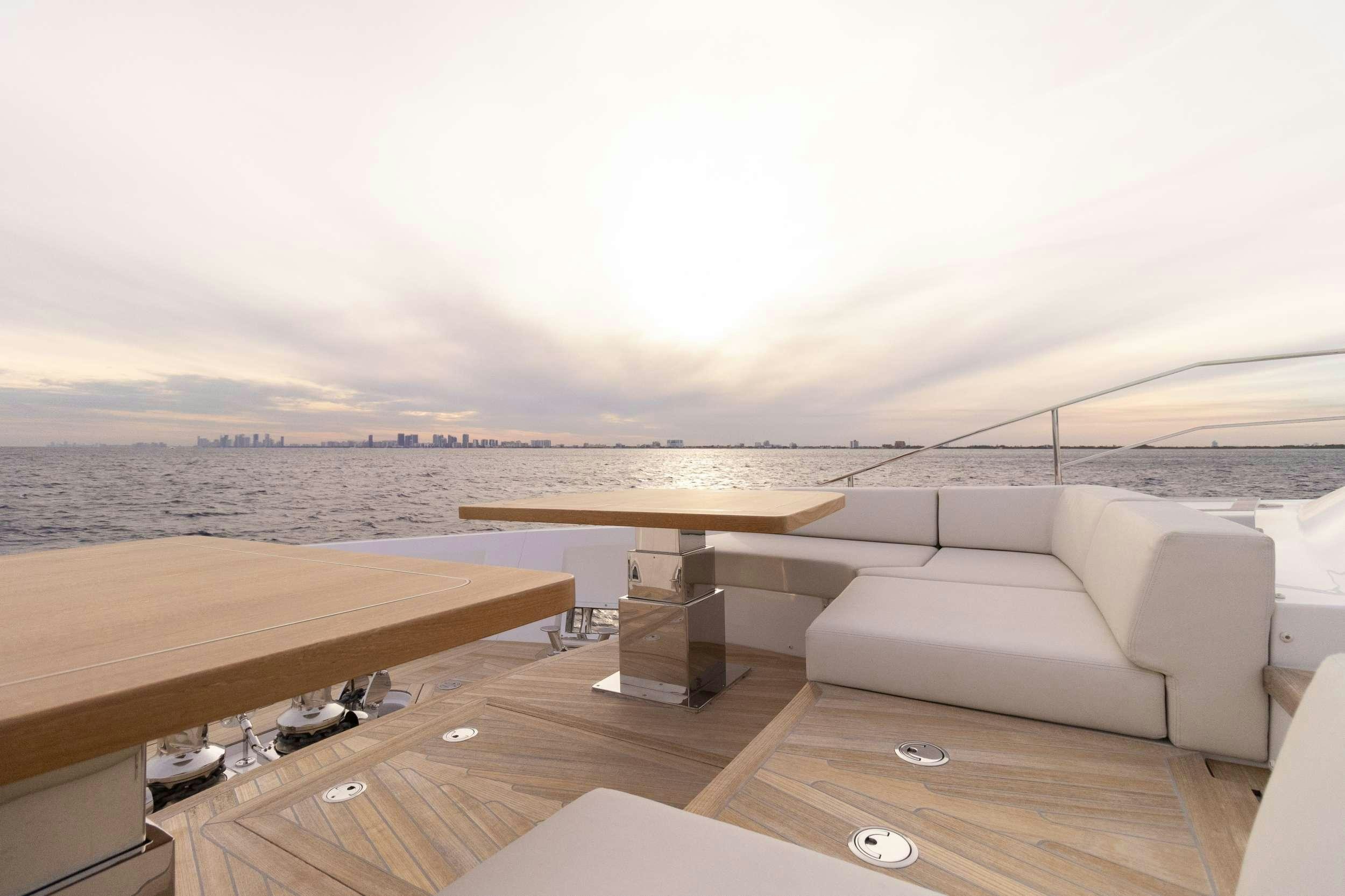 a room with a couch and a table on it aboard KARMA  Yacht for Charter