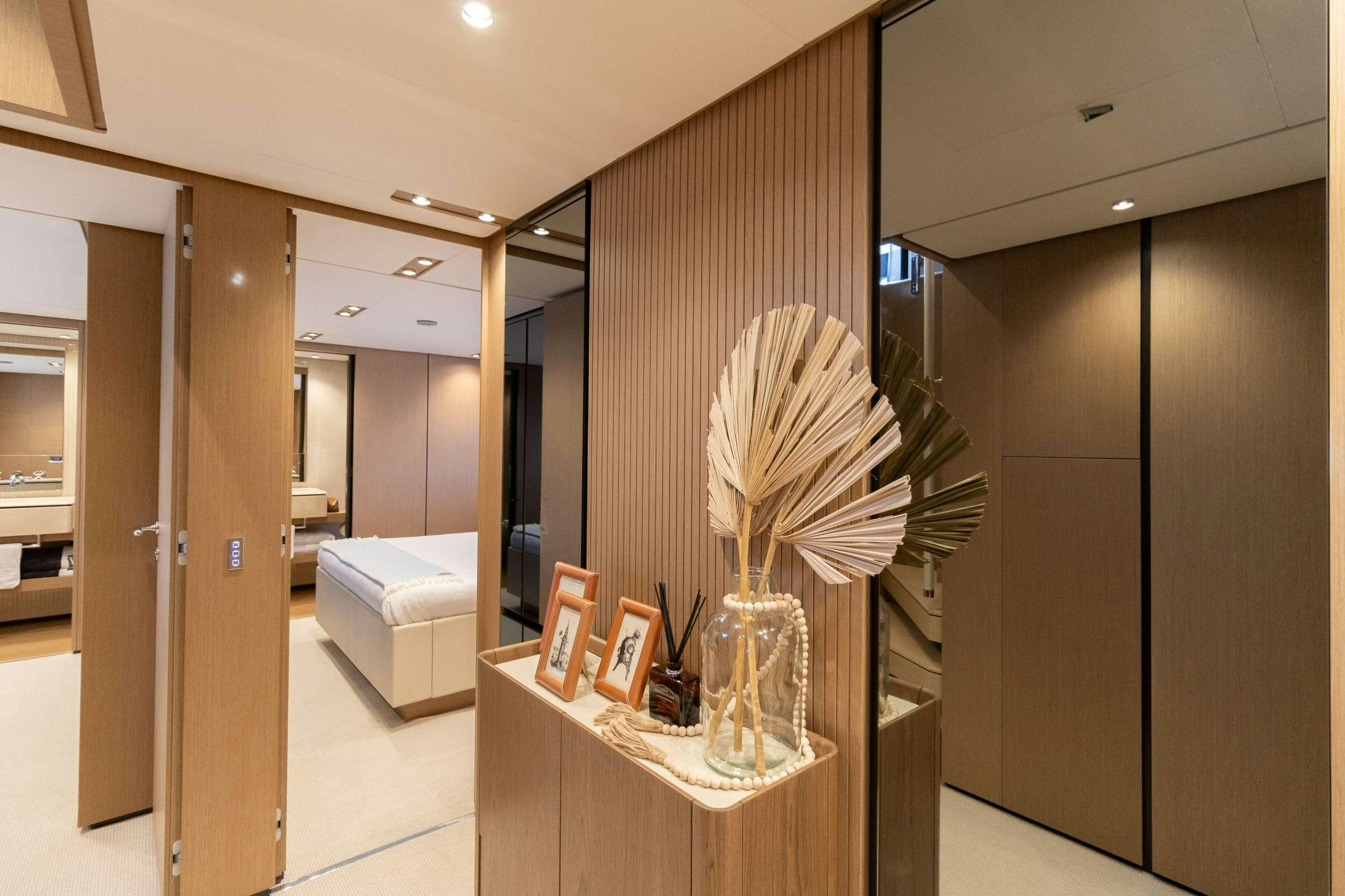 a room with a vase and a plant in it aboard KARMA  Yacht for Charter