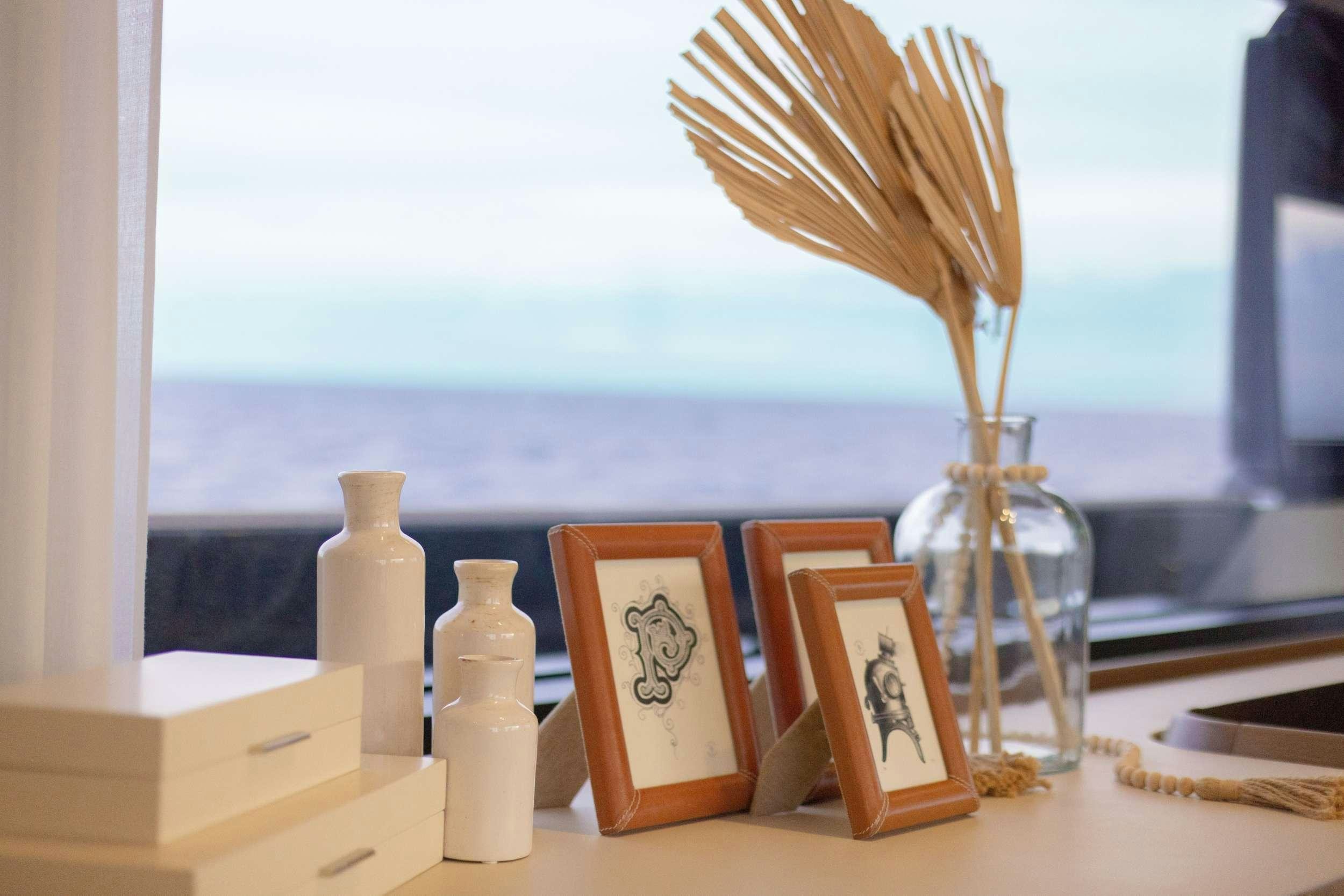 a vase with flowers and candles on a table aboard KARMA  Yacht for Charter
