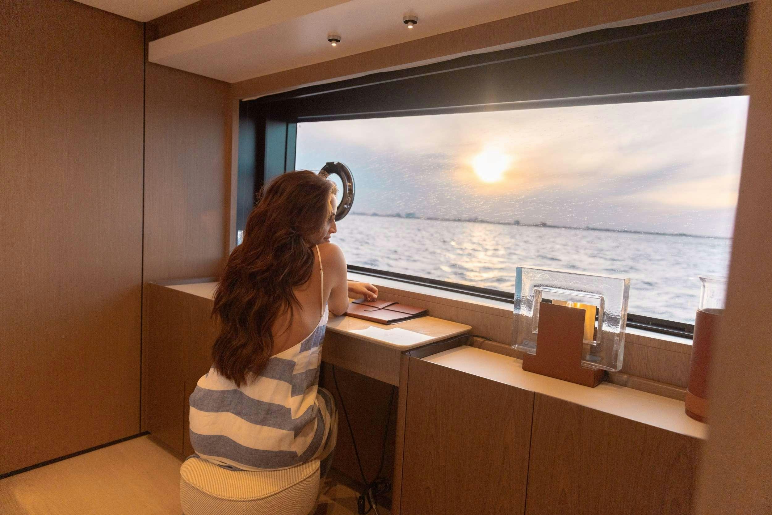 a person sitting at a desk aboard KARMA  Yacht for Charter