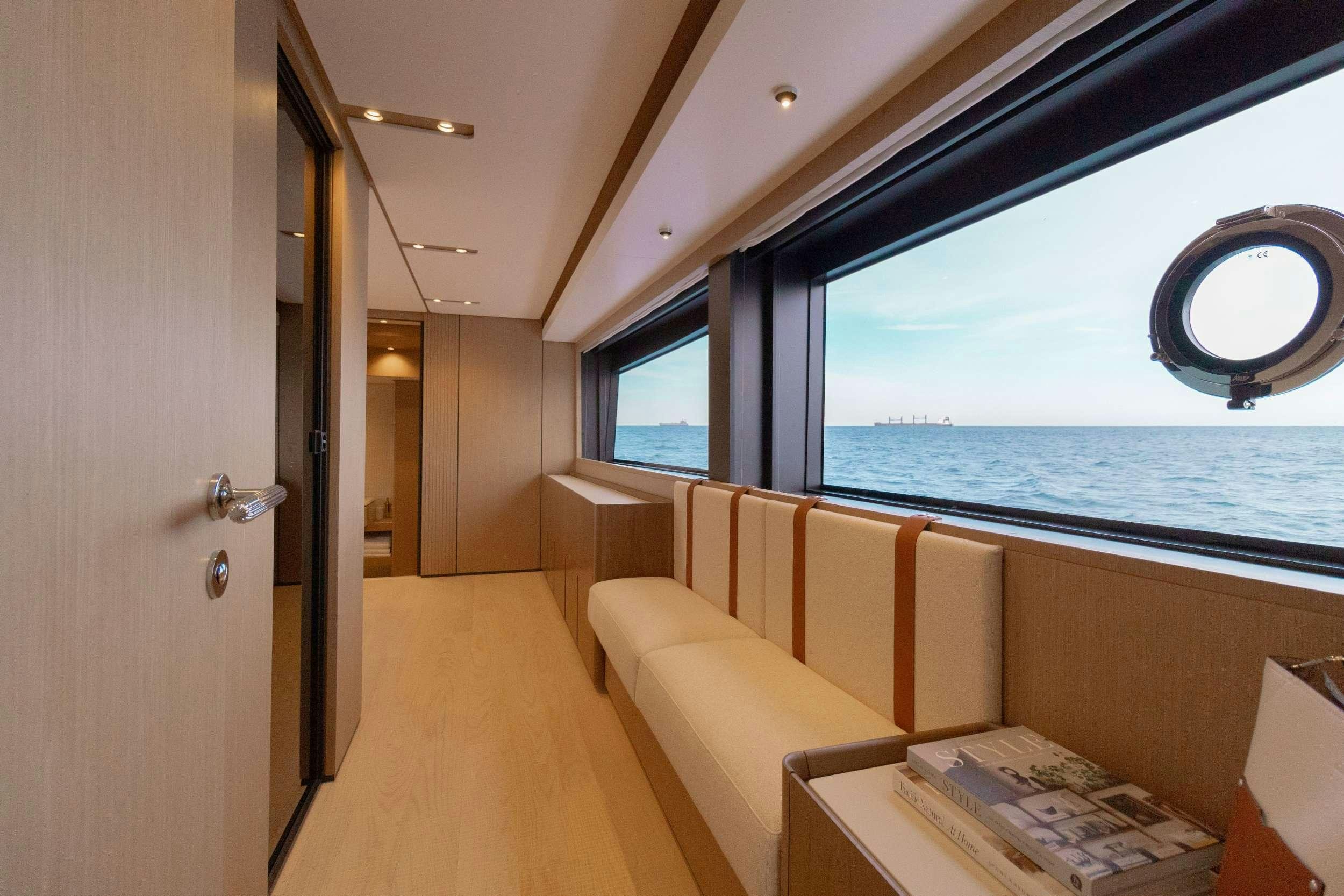 a room with a bed and a window aboard KARMA  Yacht for Charter