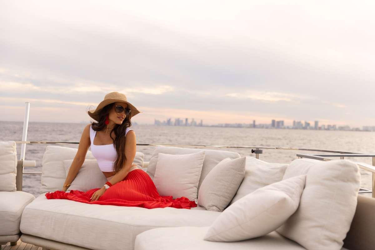 a person sitting on a couch aboard KARMA  Yacht for Charter