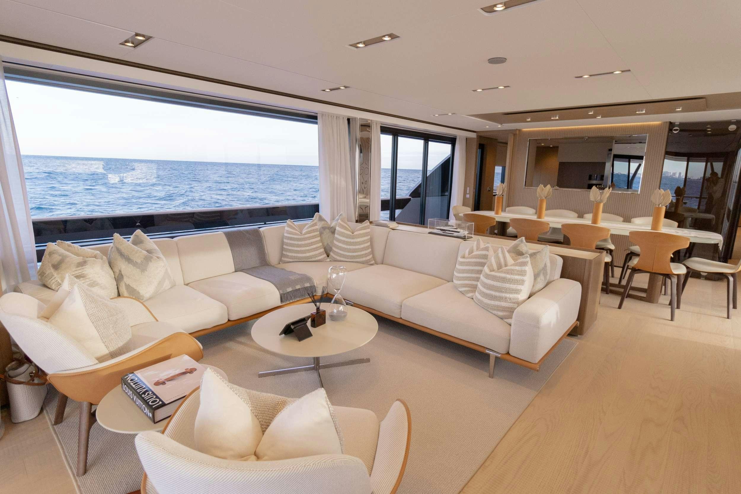 a living room with a large window aboard KARMA  Yacht for Charter