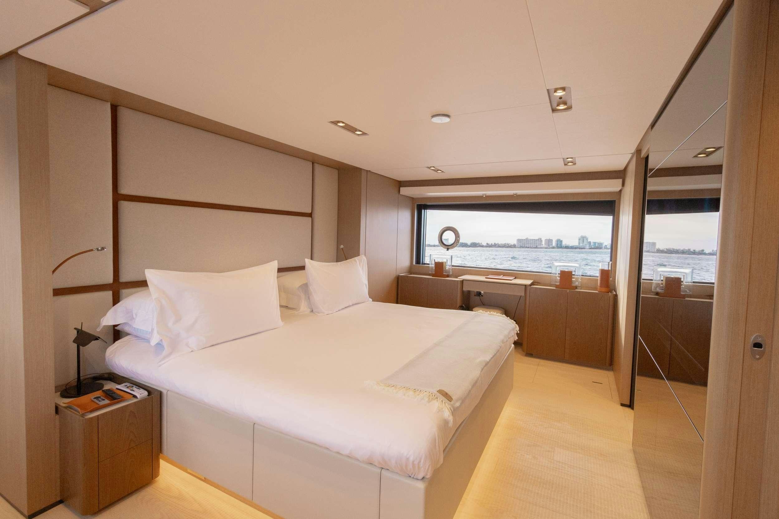 a bedroom with a large bed aboard KARMA  Yacht for Charter