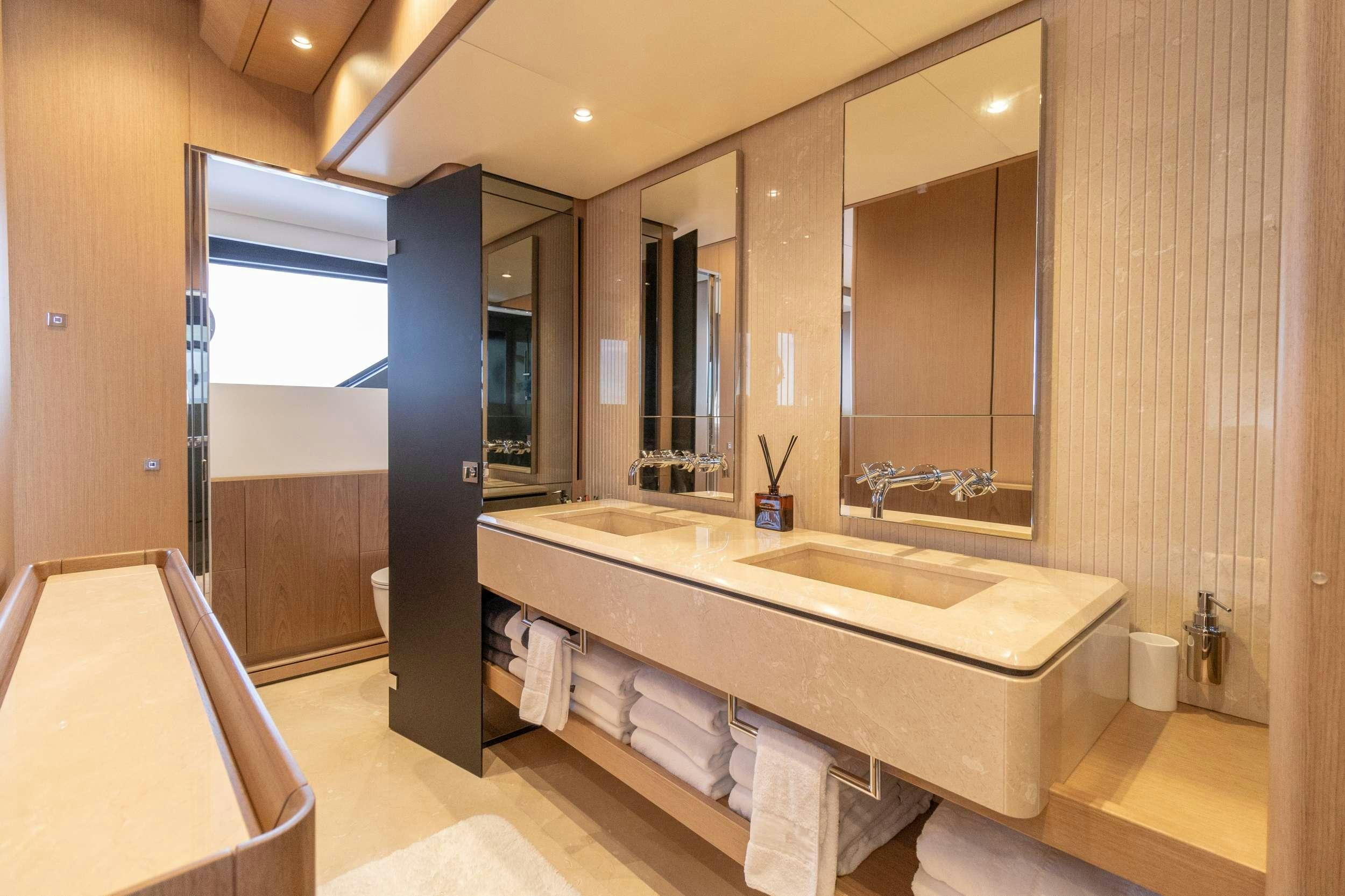 a bathroom with a large mirror aboard KARMA  Yacht for Charter