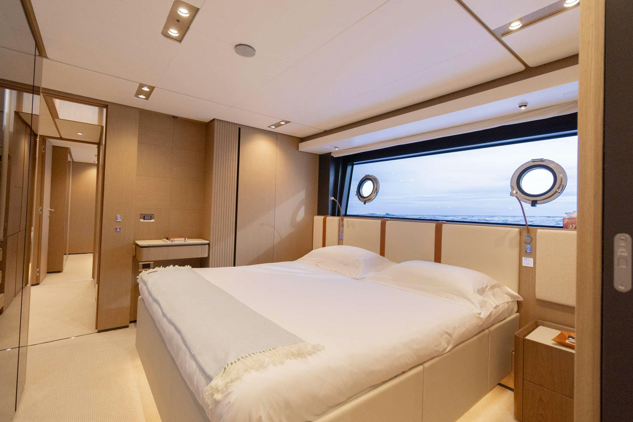 a room with a bed and a fan aboard KARMA  Yacht for Charter