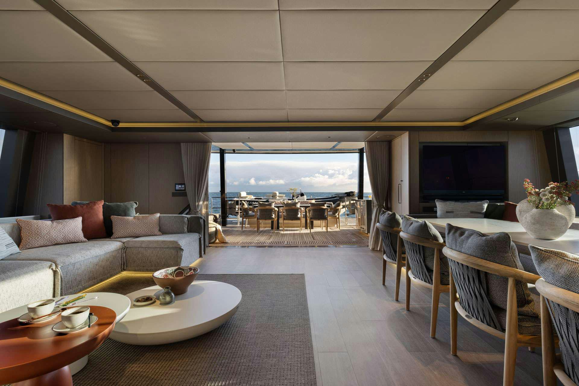 a living room with a large window aboard OTOCTONE Yacht for Charter