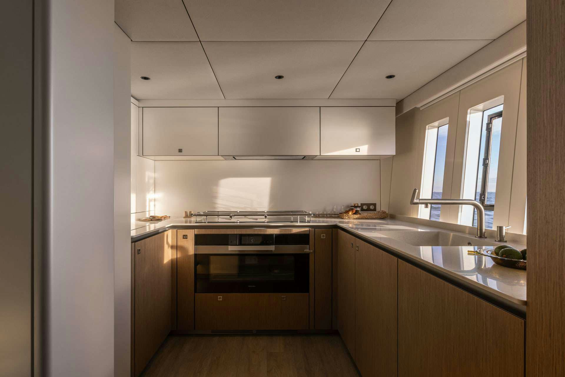 a kitchen with a stove and sink aboard OTOCTONE Yacht for Charter