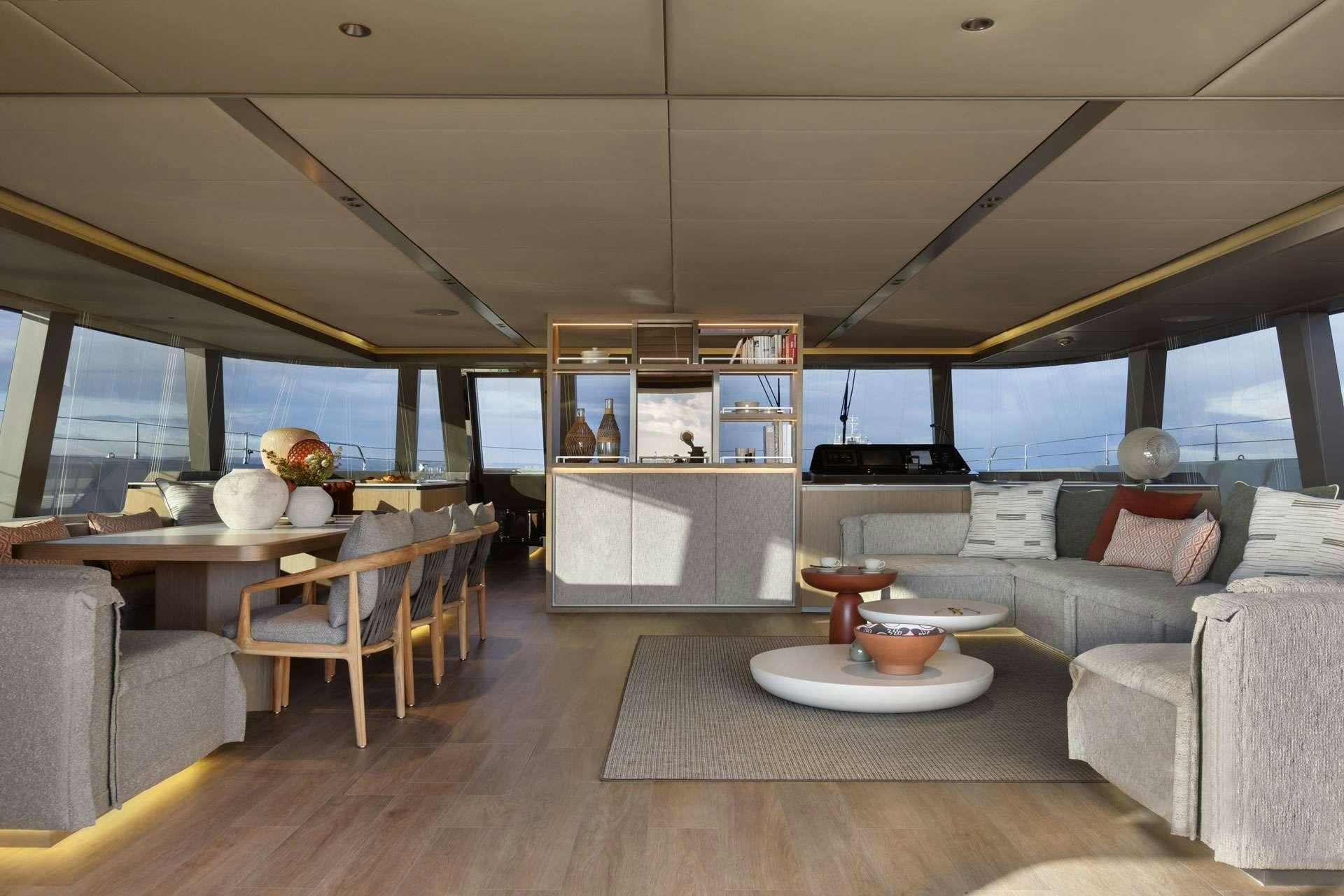 a living room with a large window aboard OTOCTONE Yacht for Charter