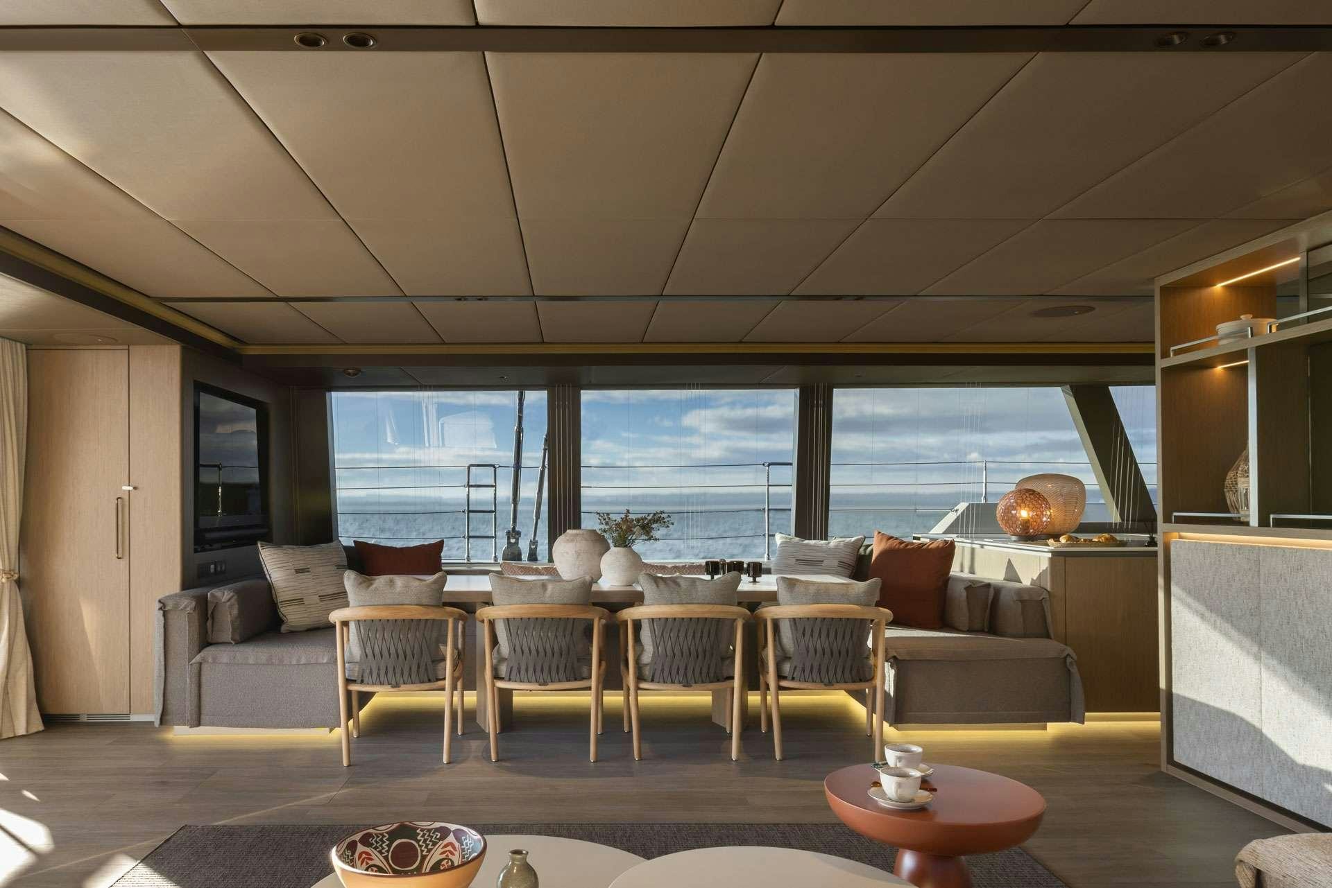 a living room with a large window aboard OTOCTONE Yacht for Charter