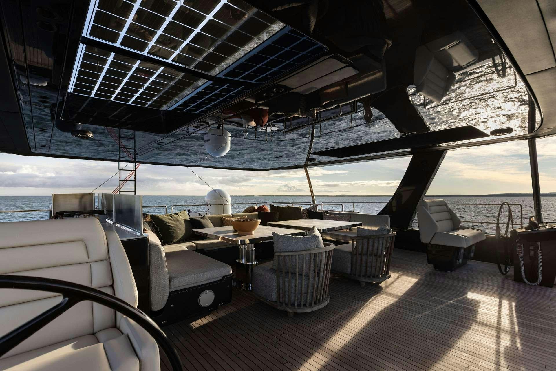 a large room with a large table and chairs aboard OTOCTONE Yacht for Charter