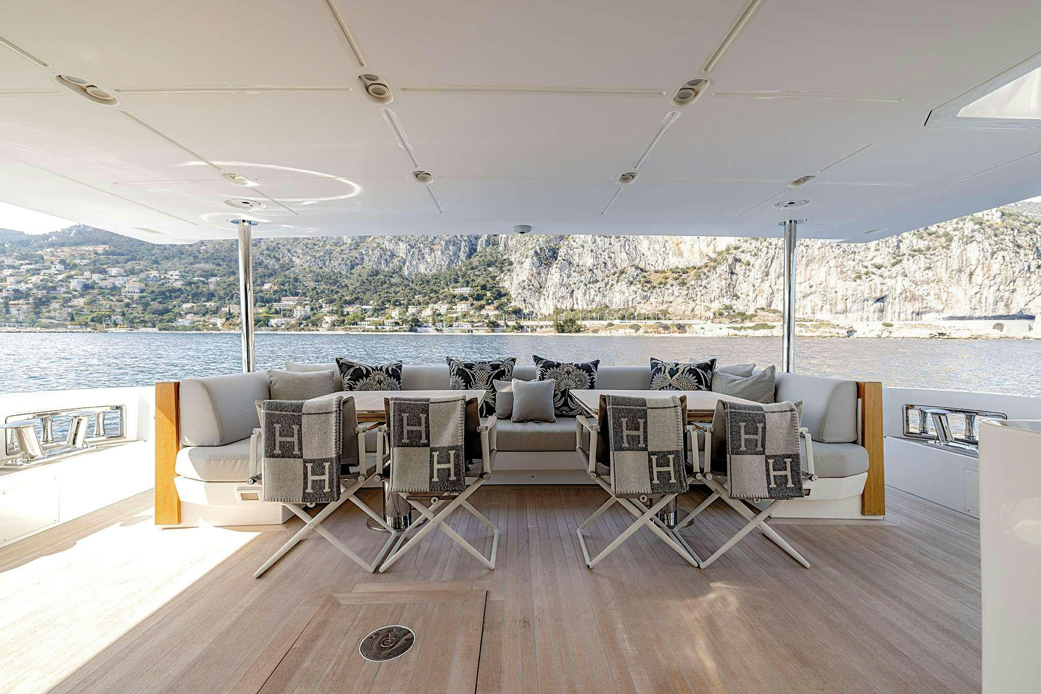 a room with a table and chairs aboard NEMESIS Yacht for Charter