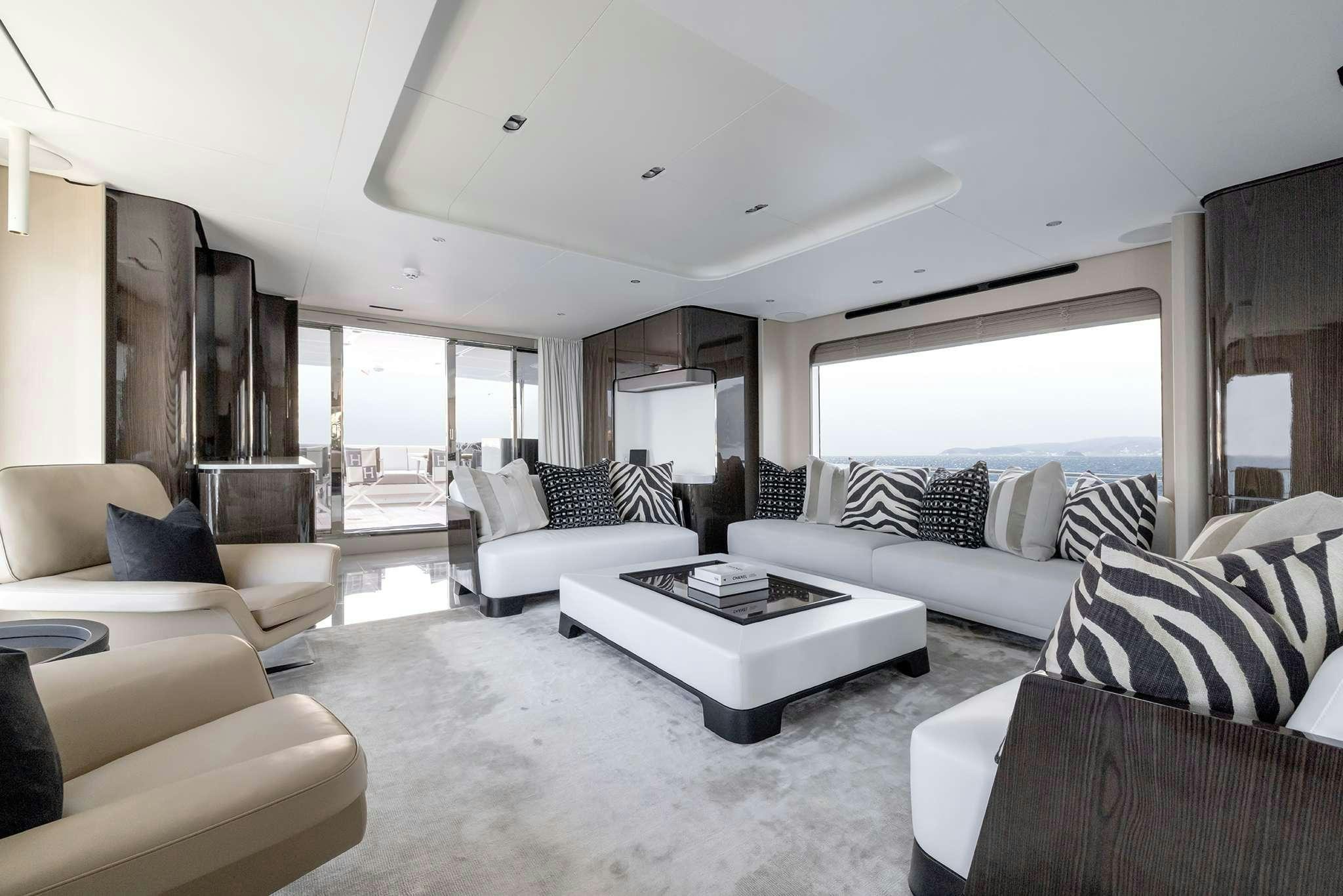 a living room with white furniture aboard NEMESIS Yacht for Charter