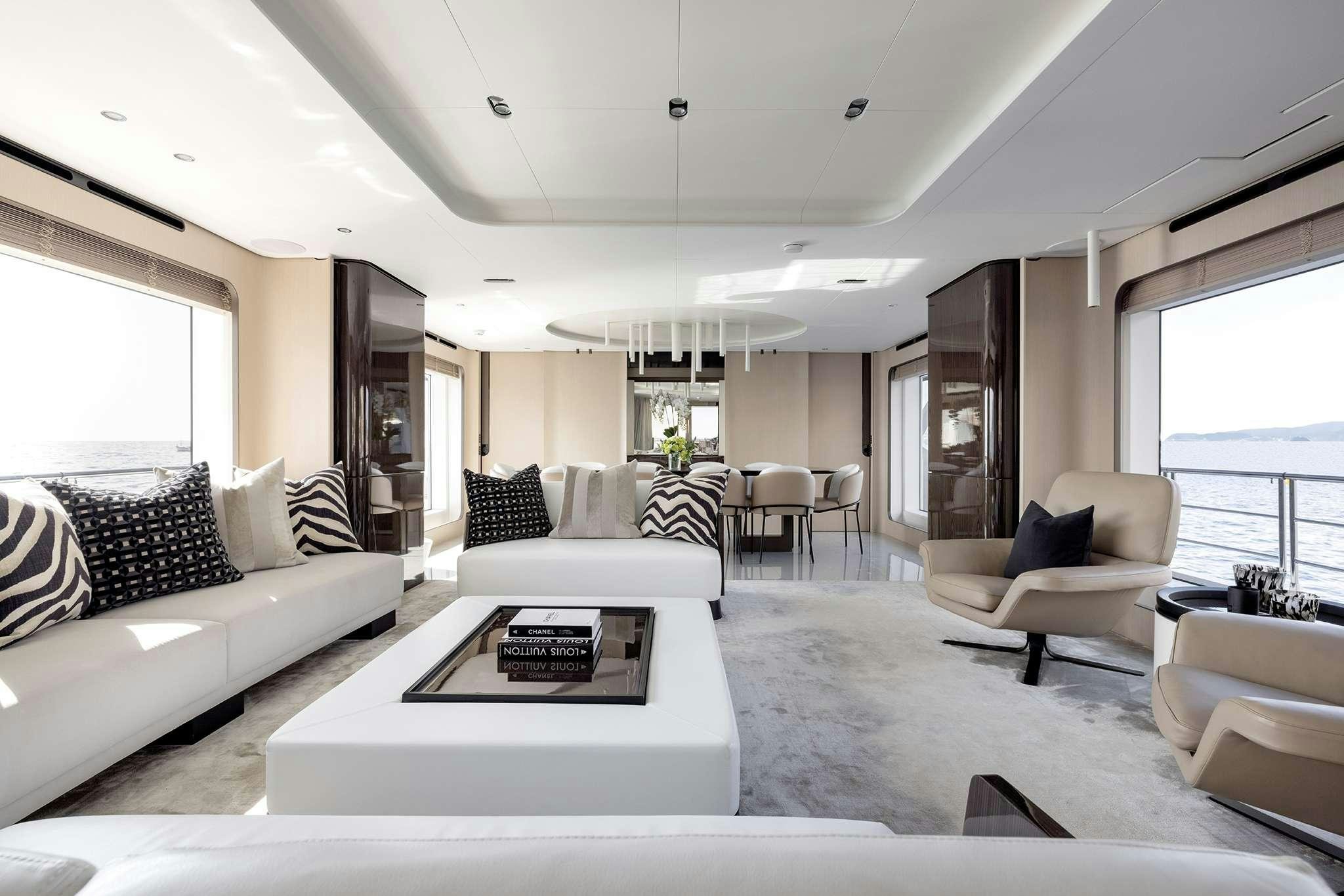 a living room with white furniture aboard NEMESIS Yacht for Charter