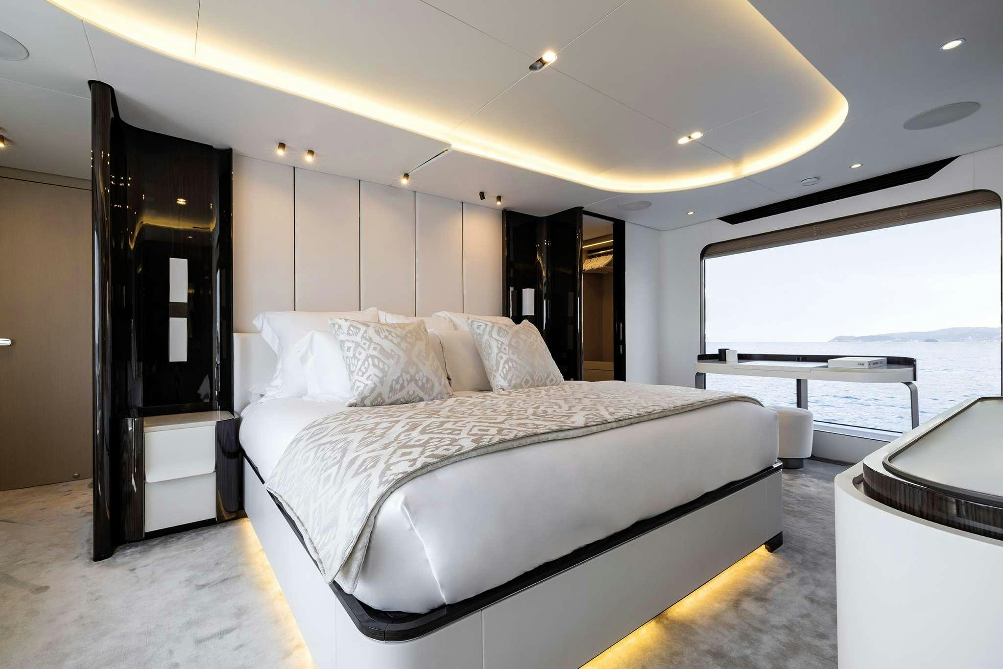 a bed with a white sheet aboard NEMESIS Yacht for Charter