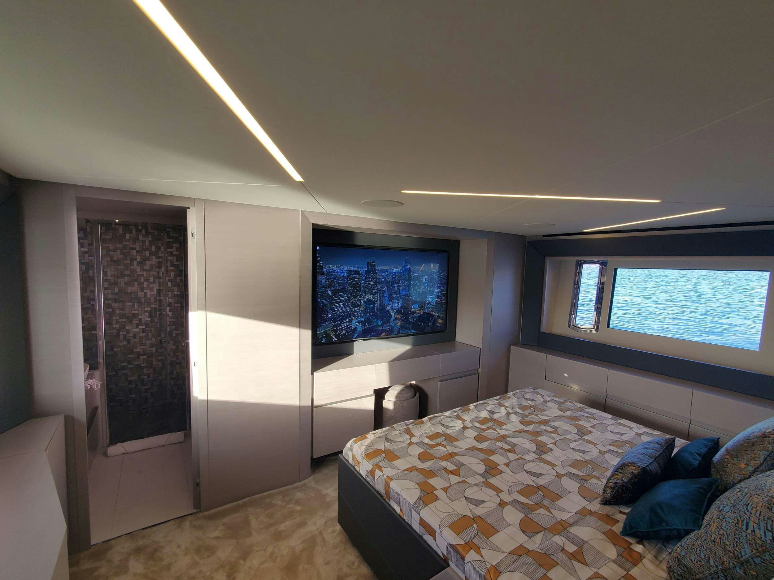 a bedroom with a bed and a tv aboard AMICI Yacht for Charter