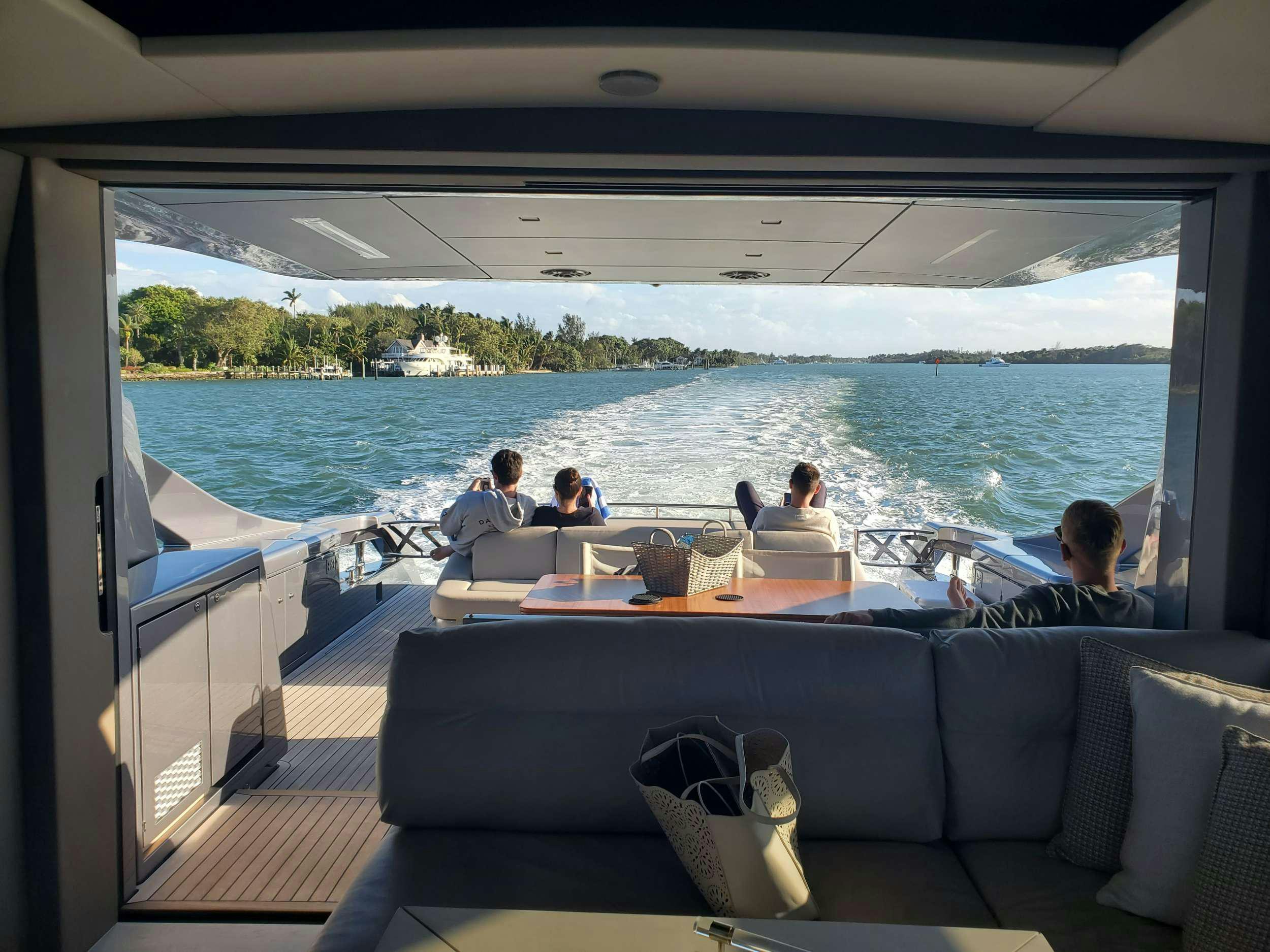 a group of people sitting at a table on a boat aboard AMICI Yacht for Charter
