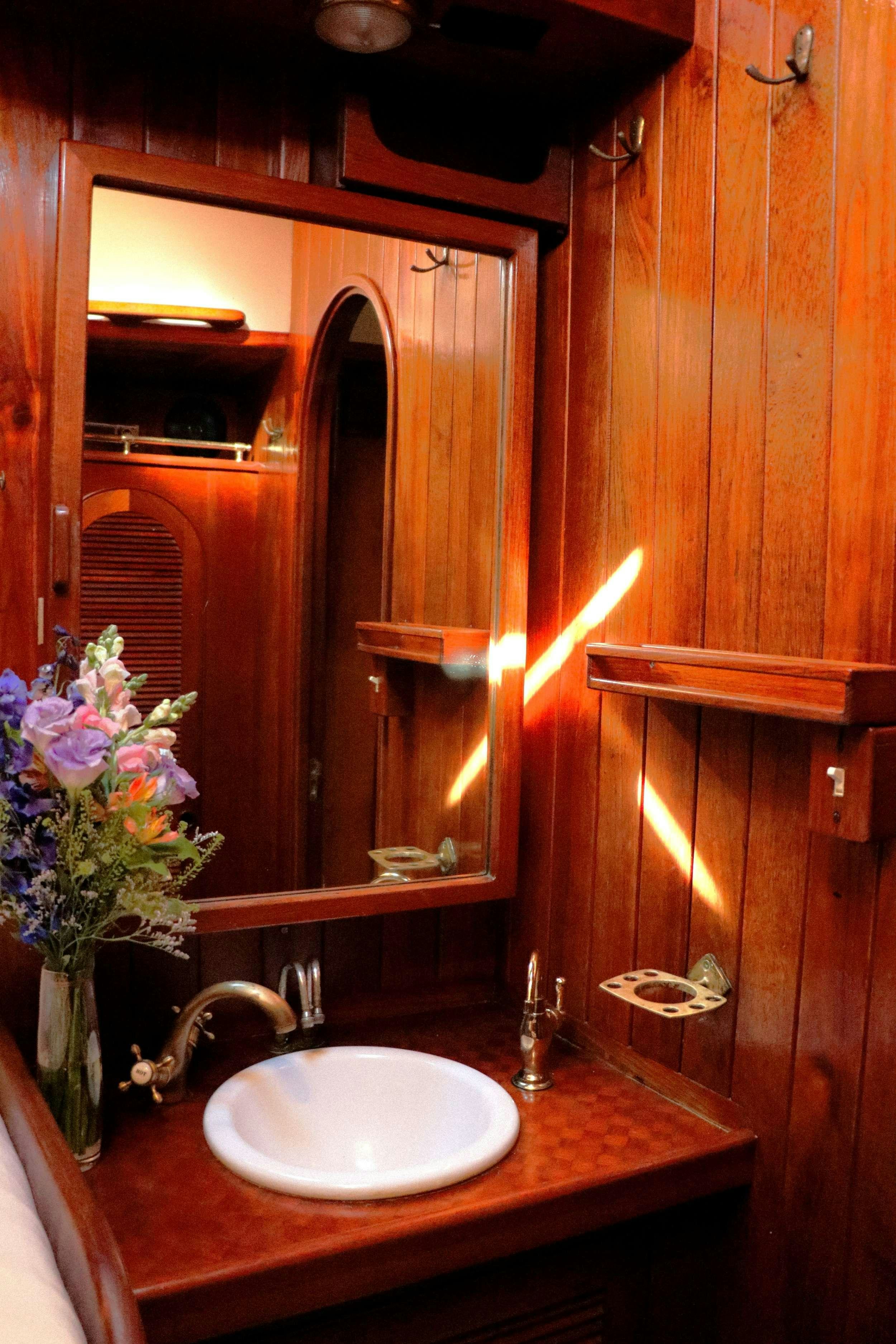 a bathroom with a sink and mirror aboard TREE OF LIFE Yacht for Charter