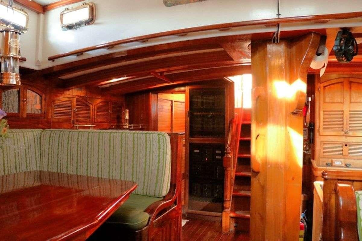 a room with a table and chairs aboard TREE OF LIFE Yacht for Charter