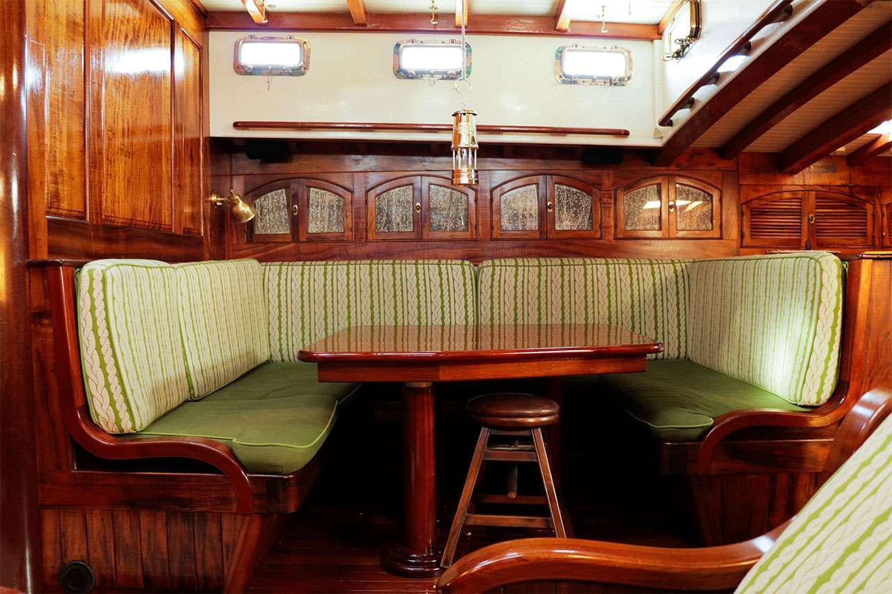 a room with a table and stools aboard TREE OF LIFE Yacht for Charter