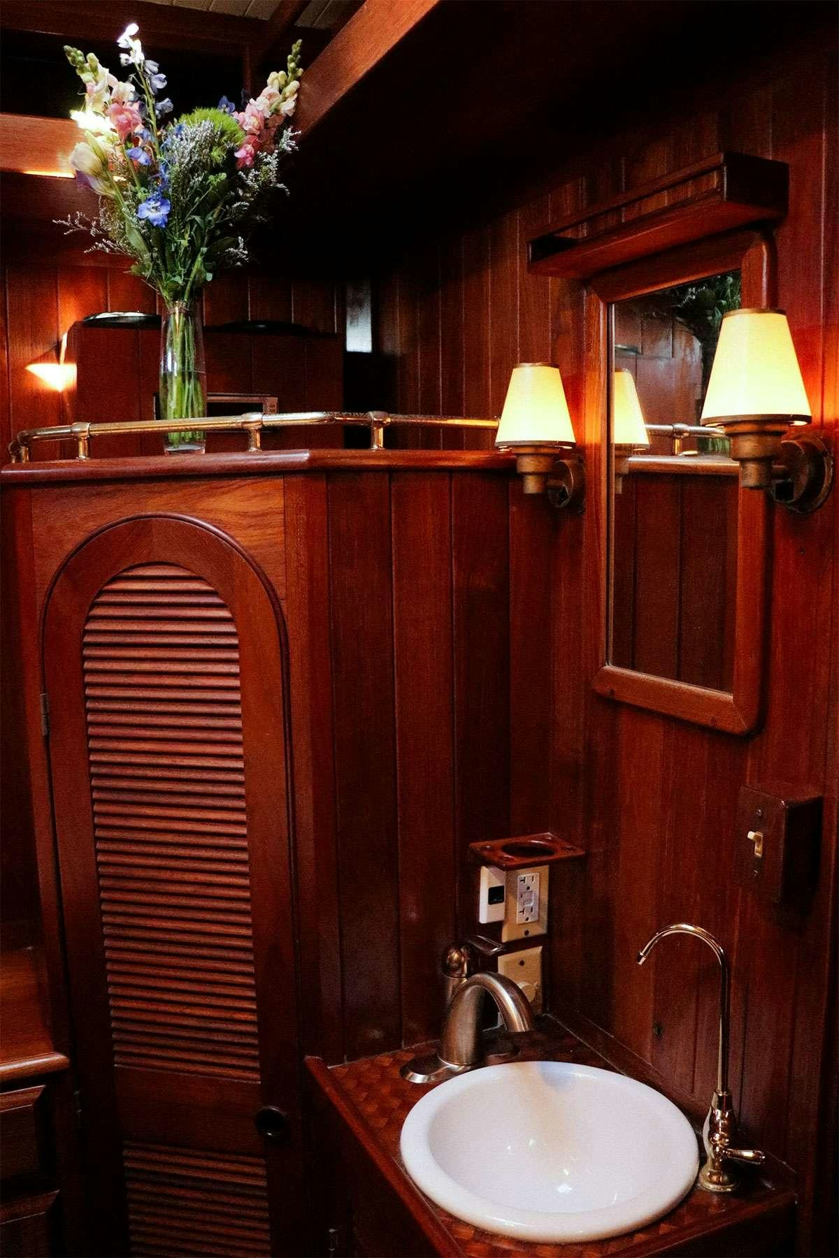 a bathroom with a sink and a mirror aboard TREE OF LIFE Yacht for Charter