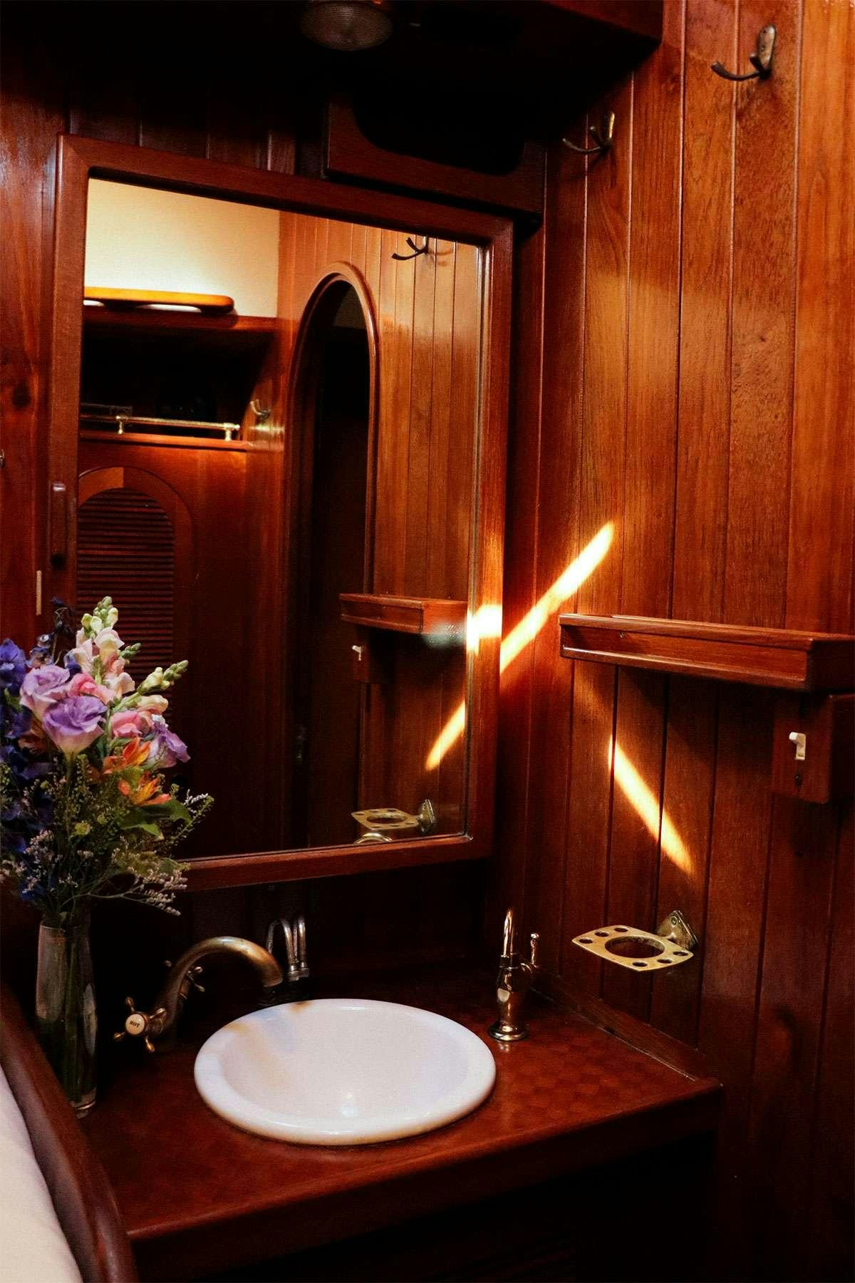 a bathroom with a sink and a mirror aboard TREE OF LIFE Yacht for Charter