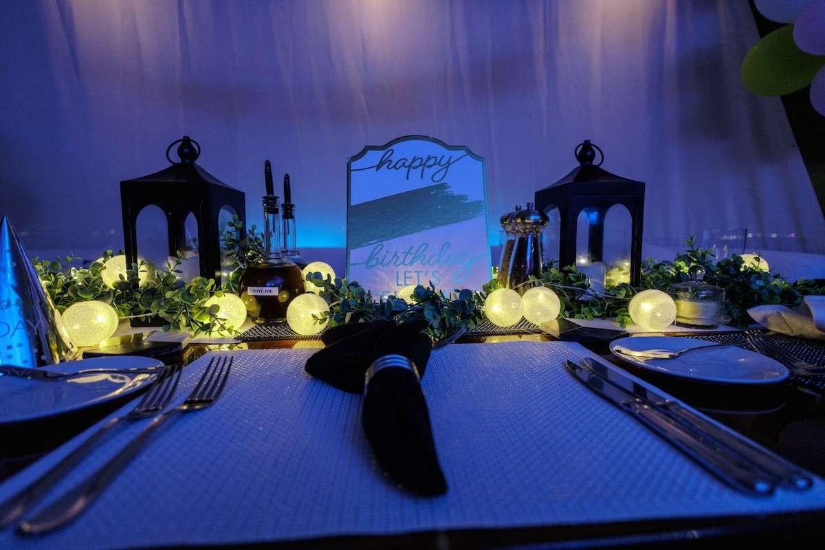 a table with plates and flowers aboard BLACKSHEEP Yacht for Charter