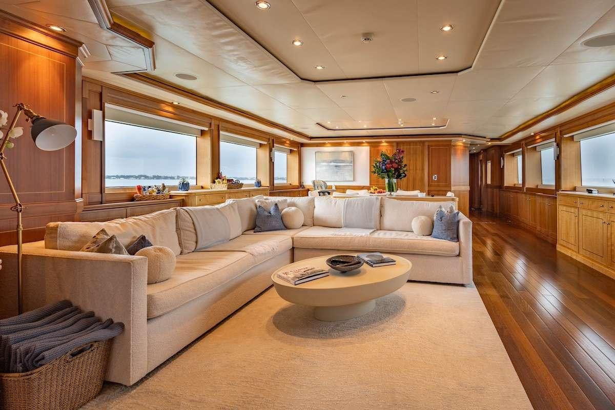 a living room with a couch and a coffee table aboard BLACKSHEEP Yacht for Charter
