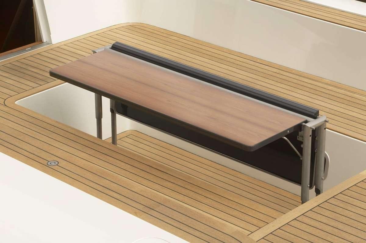 a wooden table with a black frame aboard BLACK PEARL II Yacht for Charter
