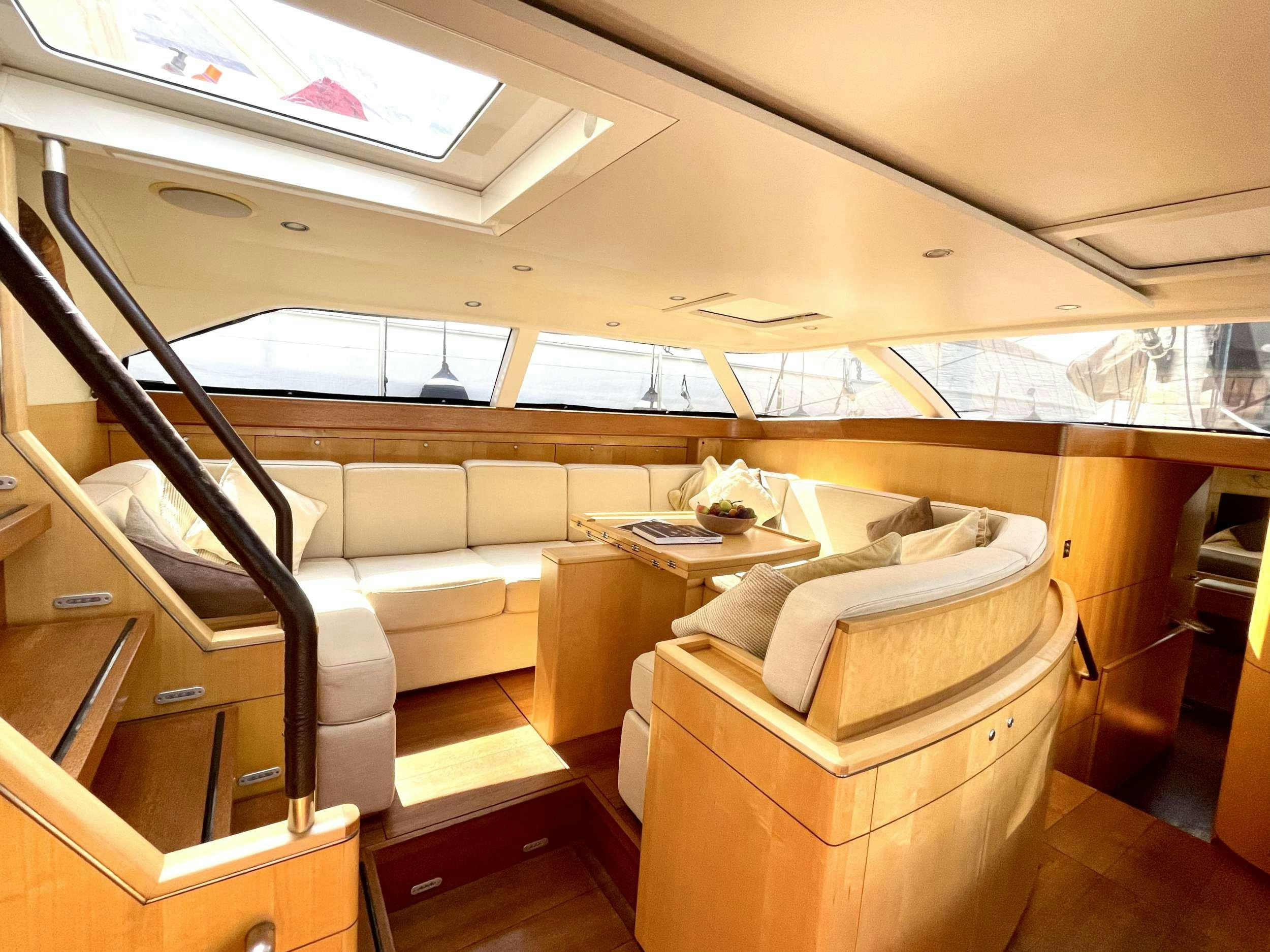 a room with a couch and a table aboard BLACK PEARL II Yacht for Charter