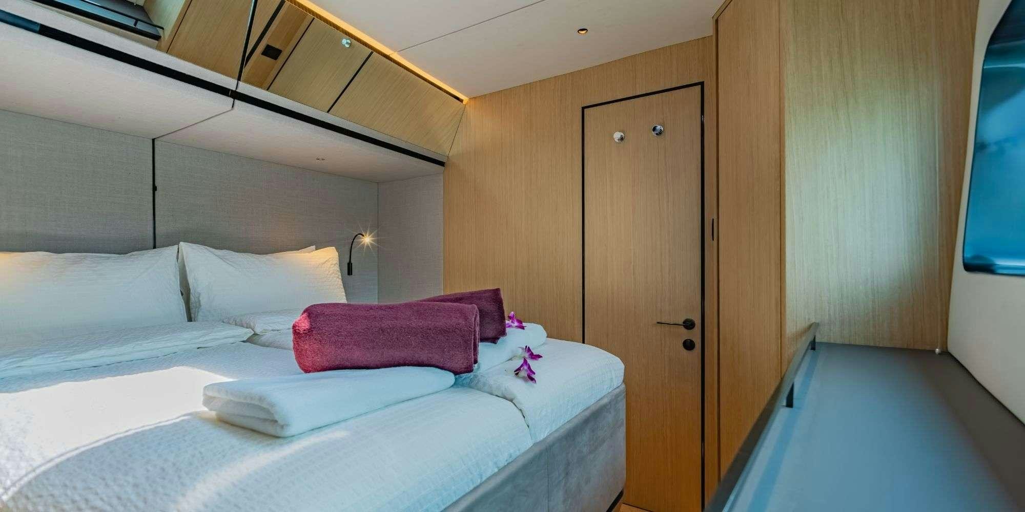 a room with two beds aboard JACK Yacht for Charter