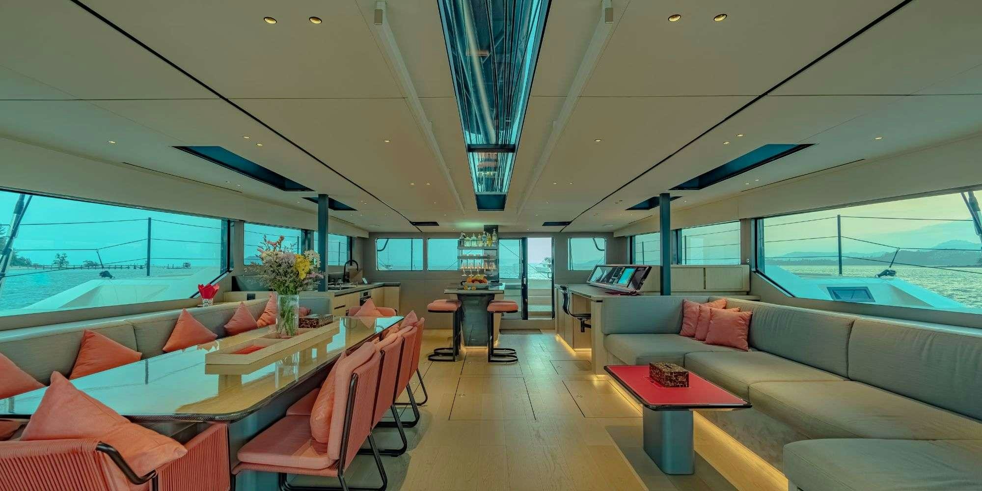 a room with a couch and a table and a window aboard JACK Yacht for Charter