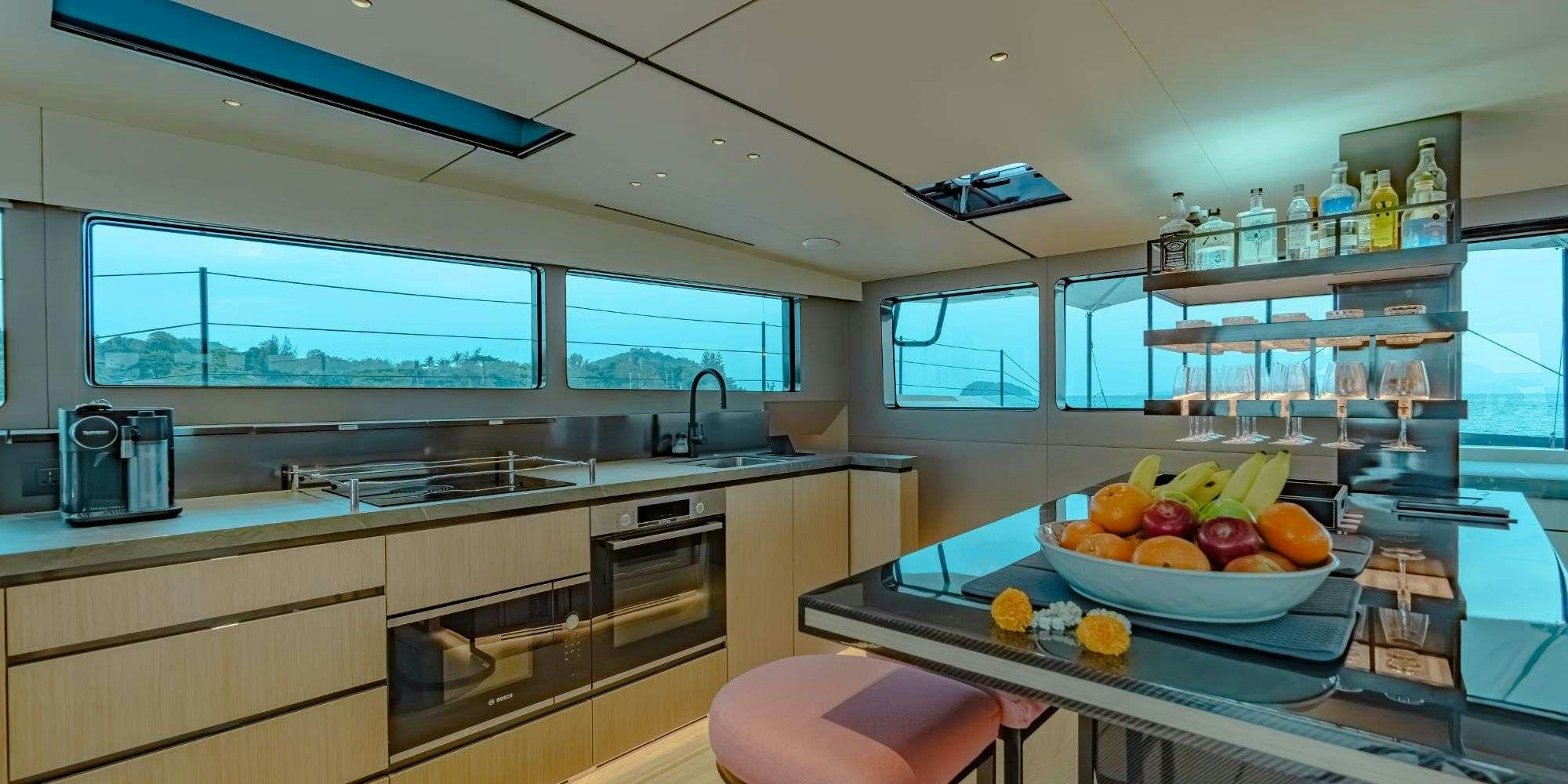 a kitchen with a bowl of fruit aboard JACK Yacht for Charter