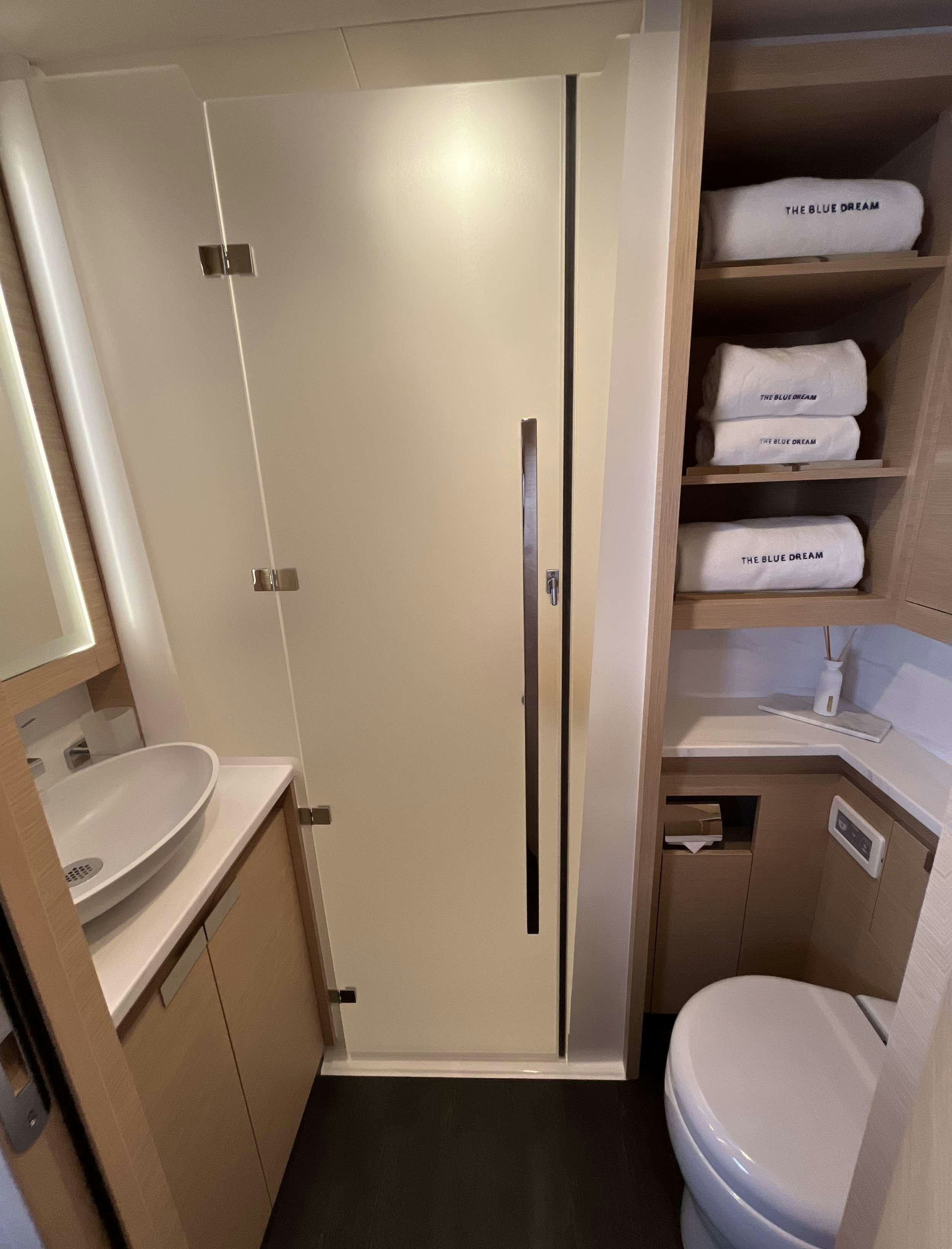 a bathroom with a toilet and sink aboard THE BLUE DREAM Yacht for Charter