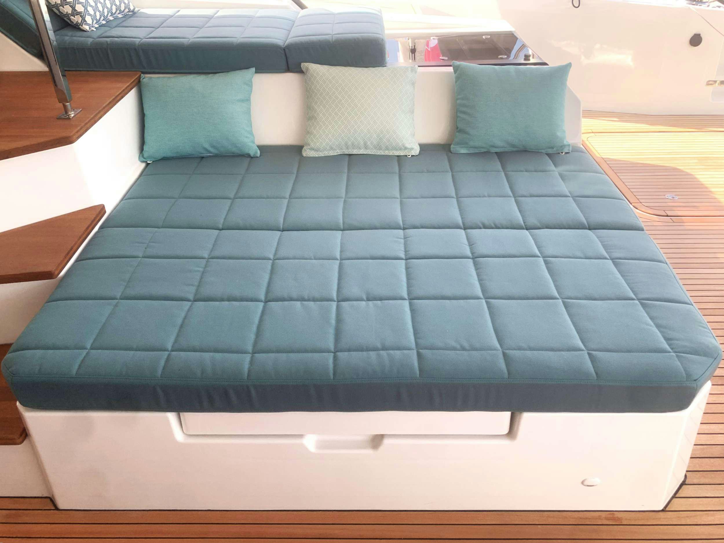 a bed with pillows aboard THE BLUE DREAM Yacht for Charter