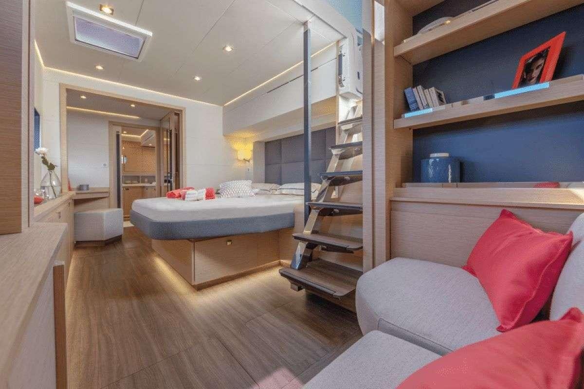 a bedroom with a bed and a bookcase aboard THE BLUE DREAM Yacht for Charter