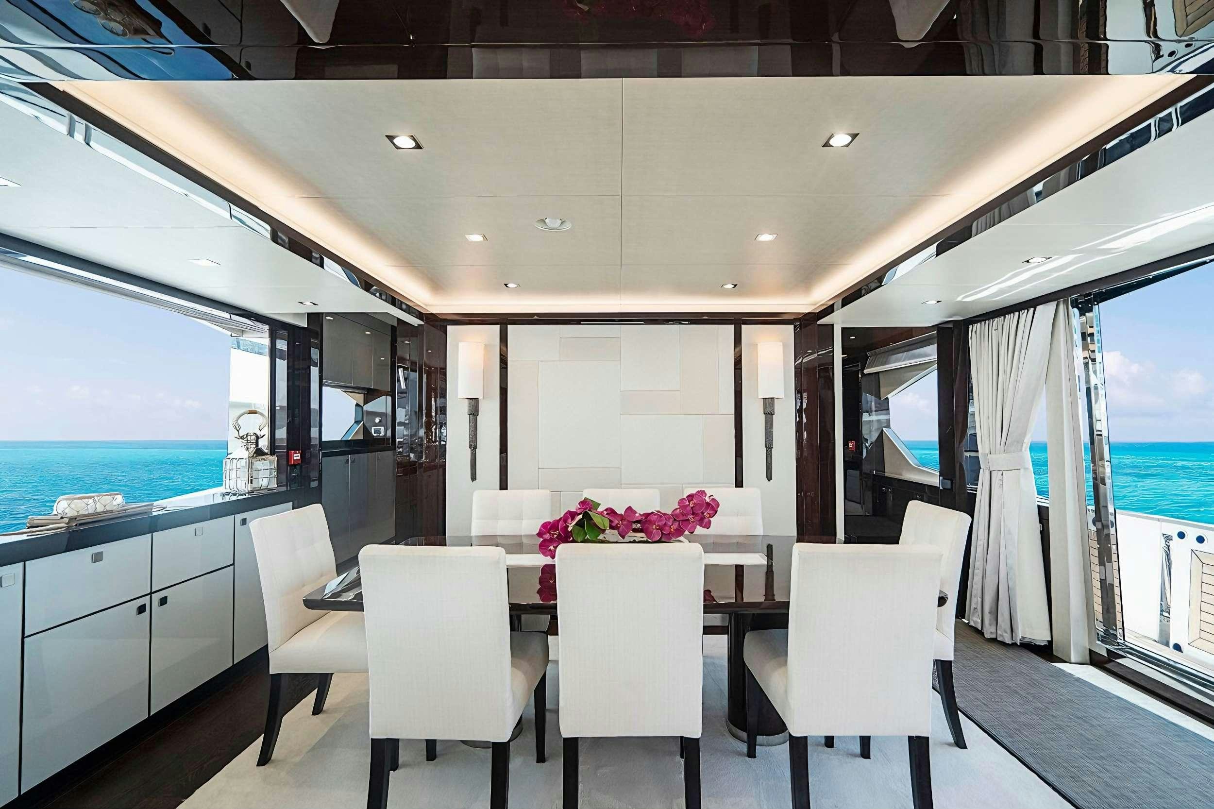 a room with a table and chairs aboard QUANTUM Yacht for Charter