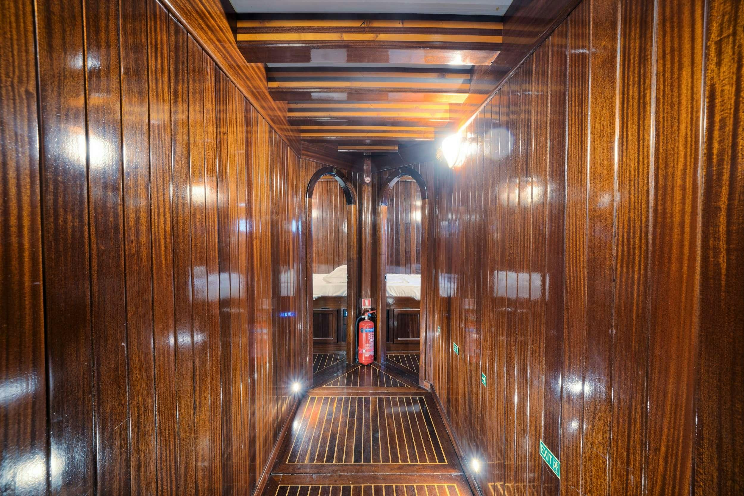 a wooden walkway with a wood railing aboard THALASSA Yacht for Charter