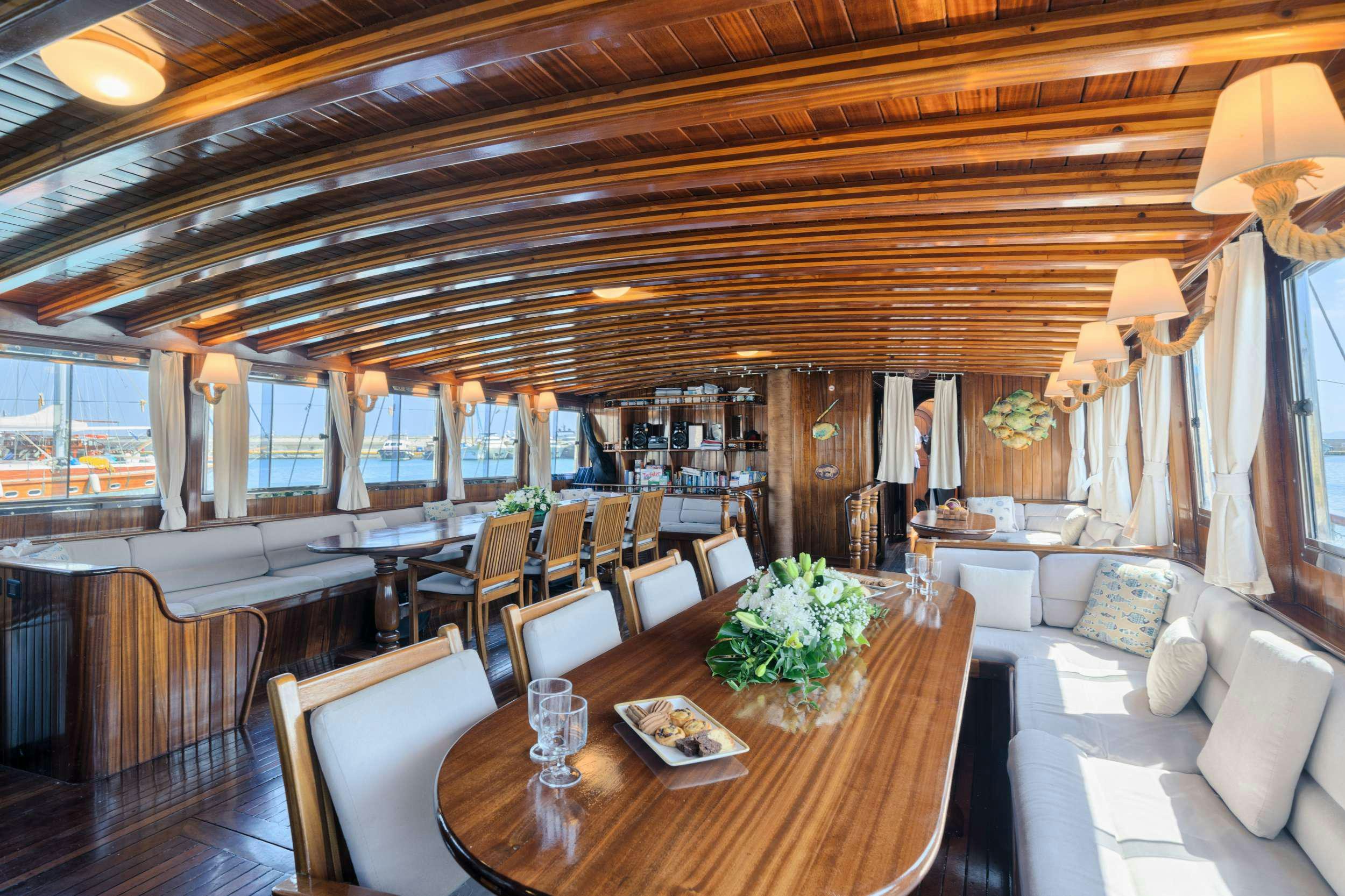 a room with a table and chairs aboard THALASSA Yacht for Charter