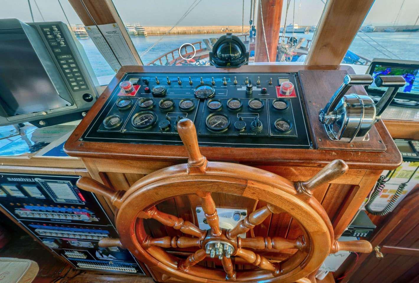 a wooden steering wheel aboard THALASSA Yacht for Charter