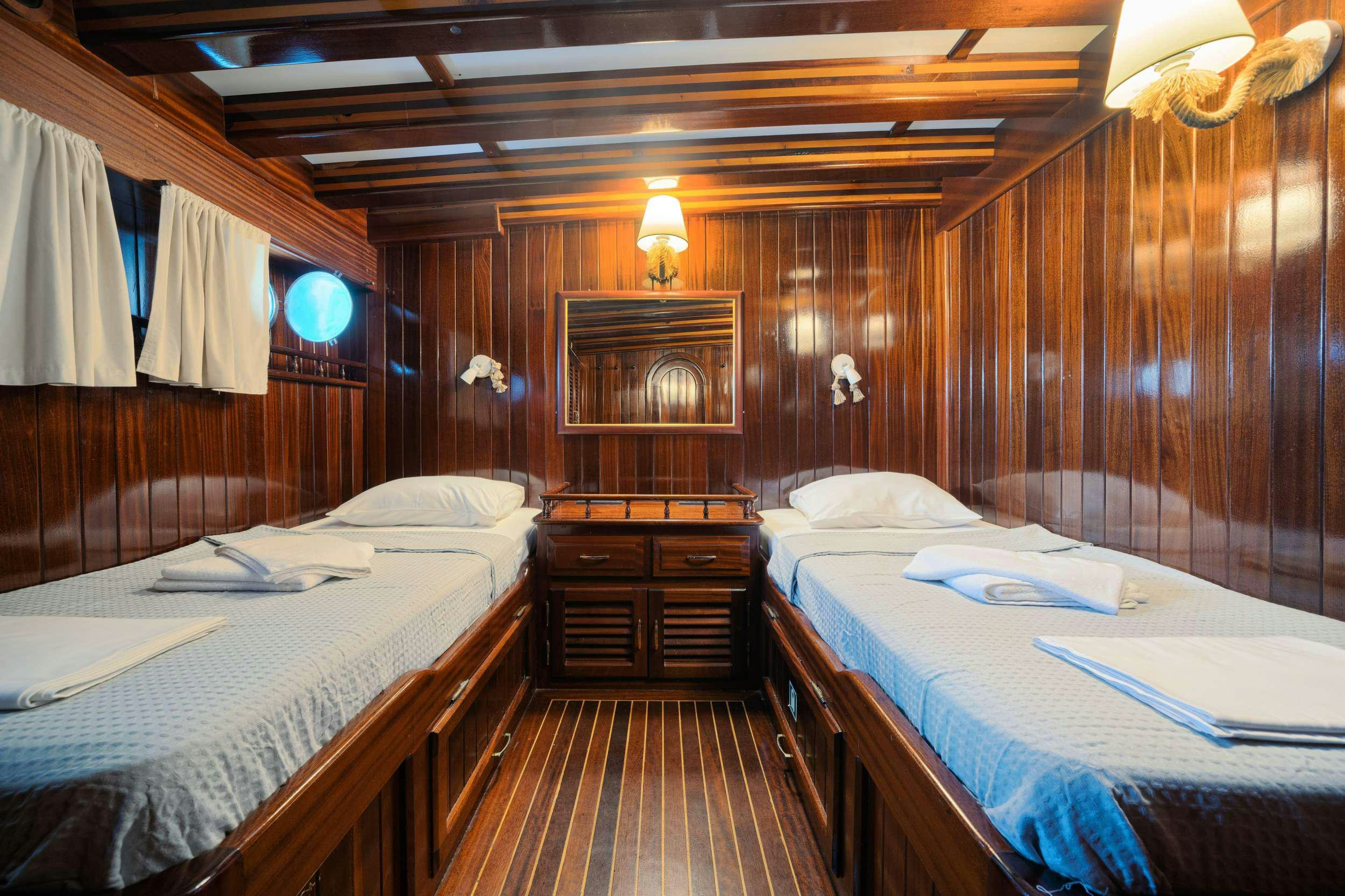 a room with two beds aboard THALASSA Yacht for Charter