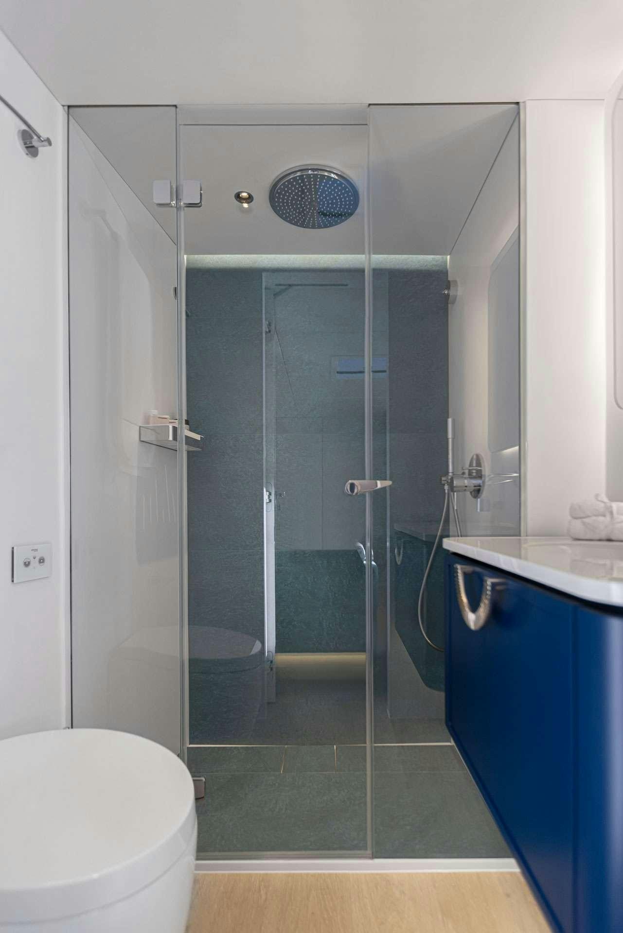 a bathroom with a glass shower aboard MISCHIEVOUS Yacht for Charter
