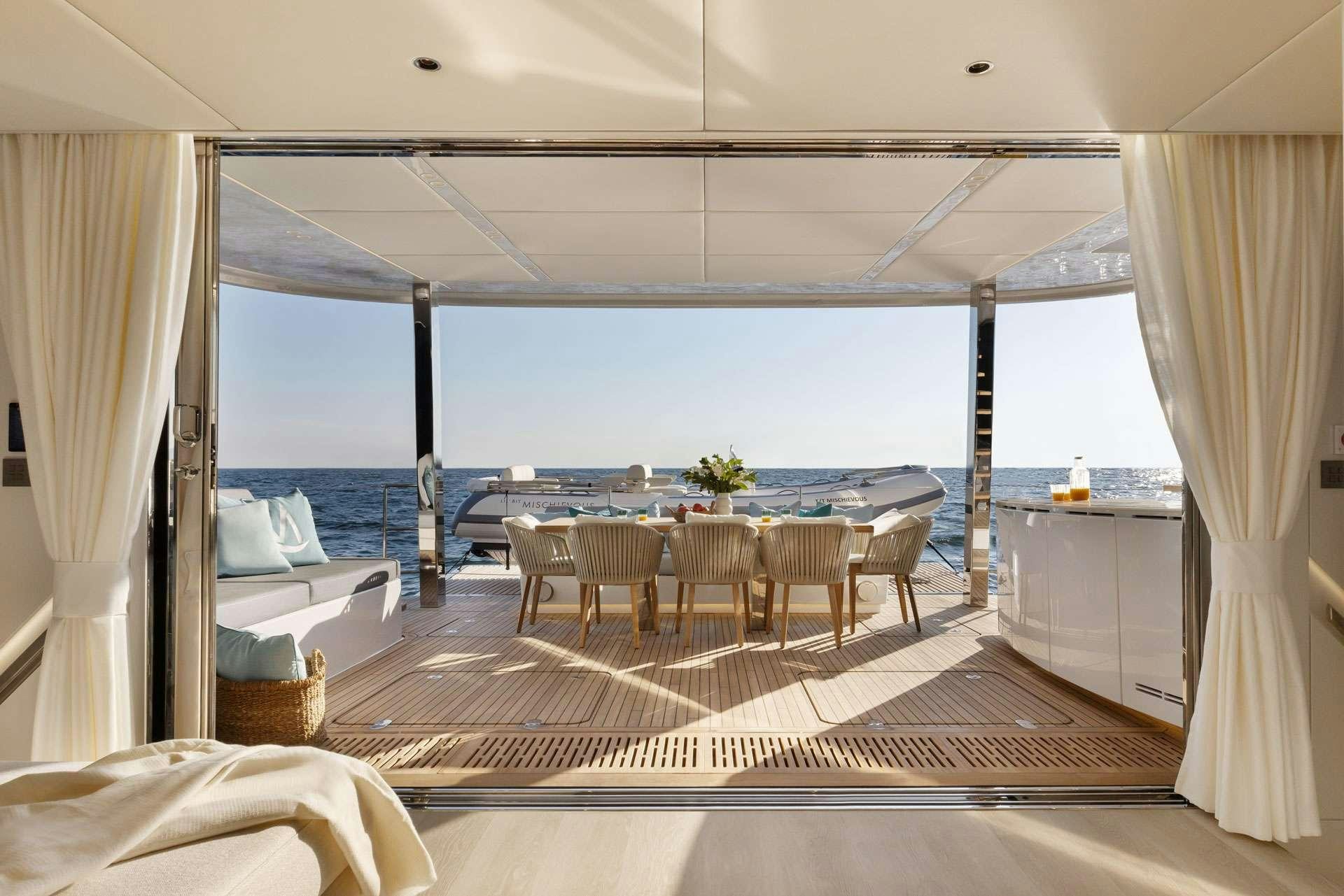 a room with a table and chairs aboard MISCHIEVOUS Yacht for Charter