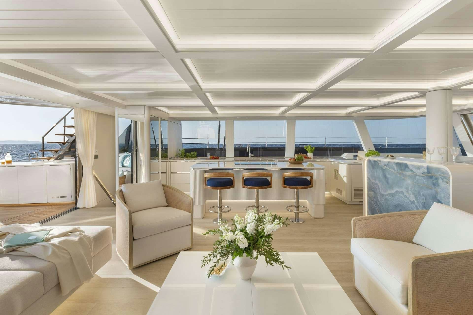 a room with a table chairs and a plant in it aboard MISCHIEVOUS Yacht for Charter