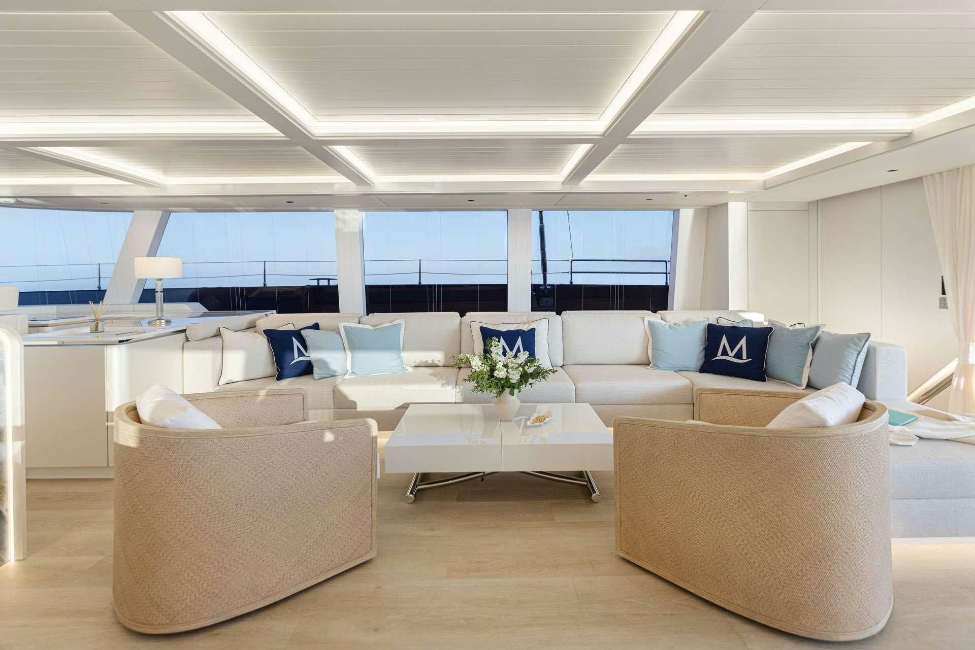 a large room with couches and tables aboard MISCHIEVOUS Yacht for Charter