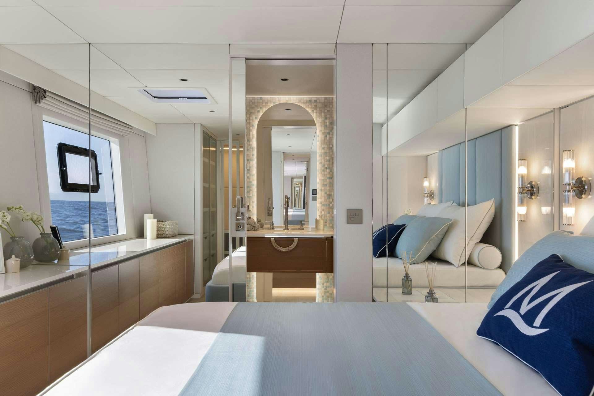 a bedroom with a large mirror aboard MISCHIEVOUS Yacht for Charter