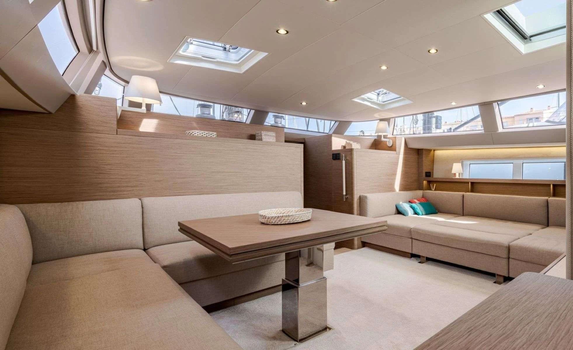 a room with a couch and a table aboard MAHINA 3 Yacht for Charter