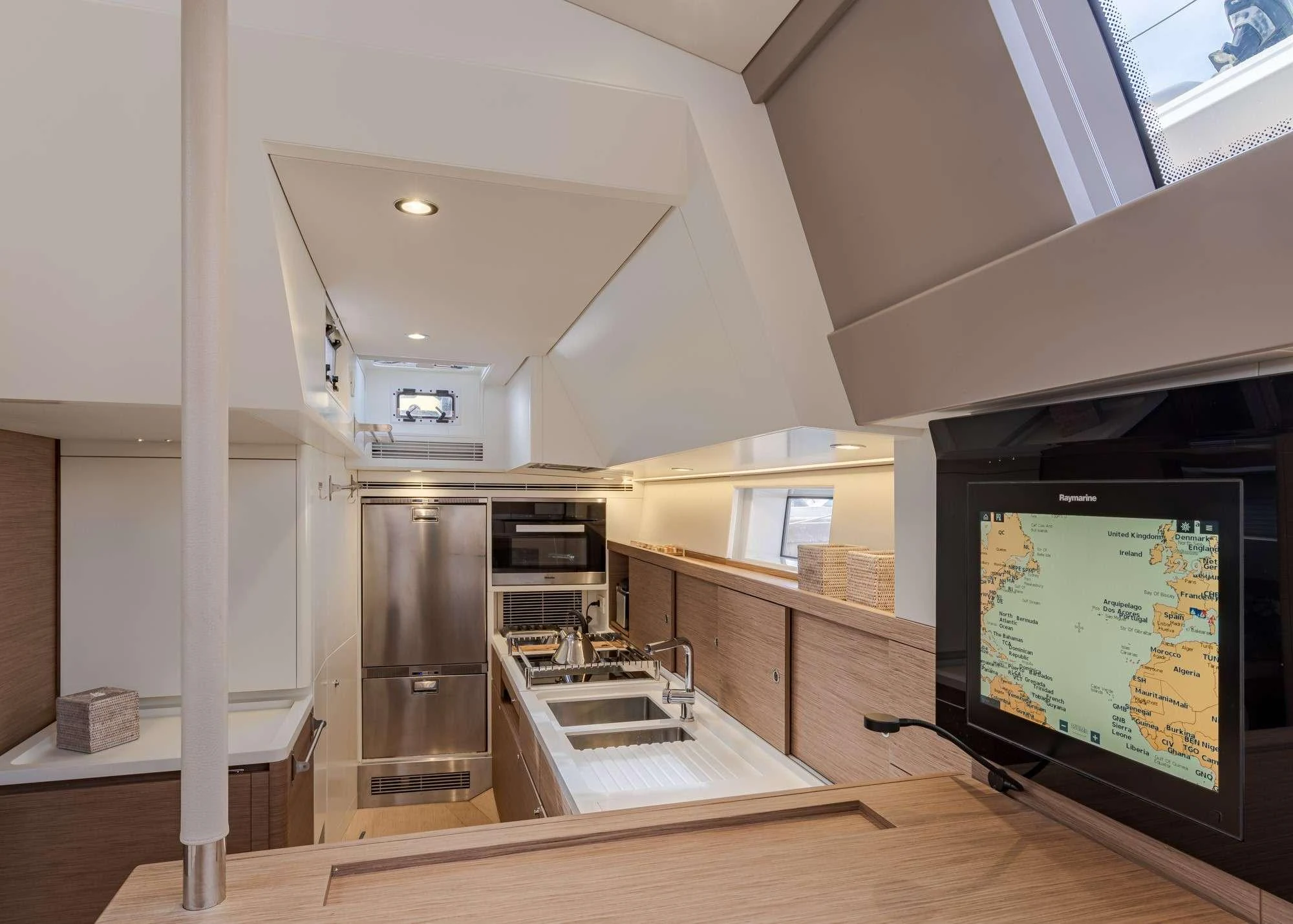 a large kitchen with a large screen aboard MAHINA 3 Yacht for Charter