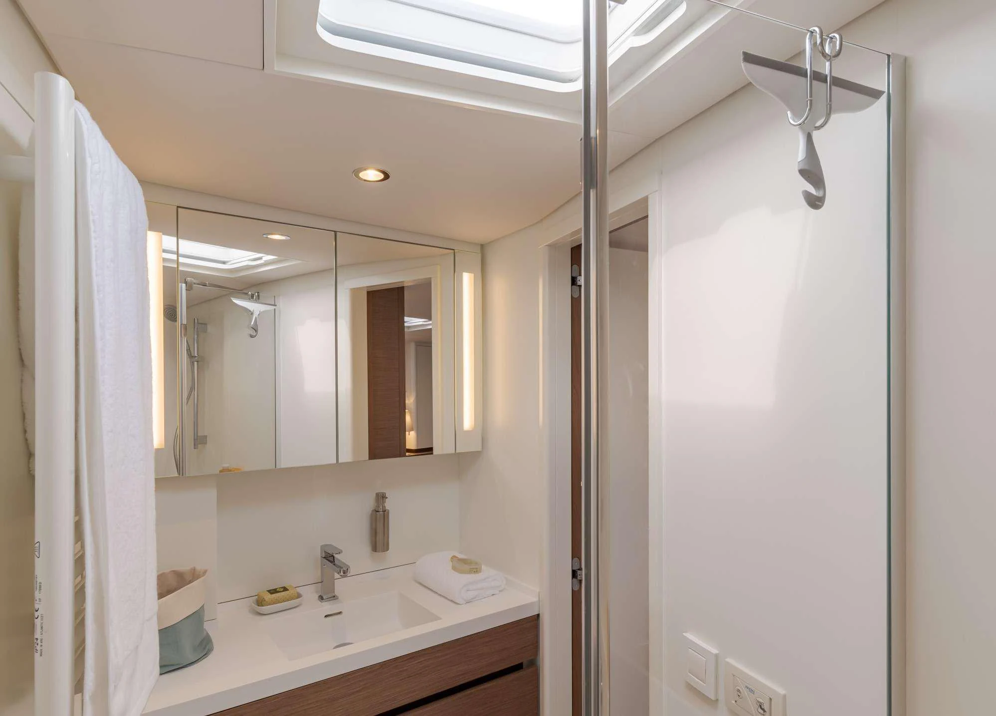 a bathroom with a sink and a mirror aboard MAHINA 3 Yacht for Charter