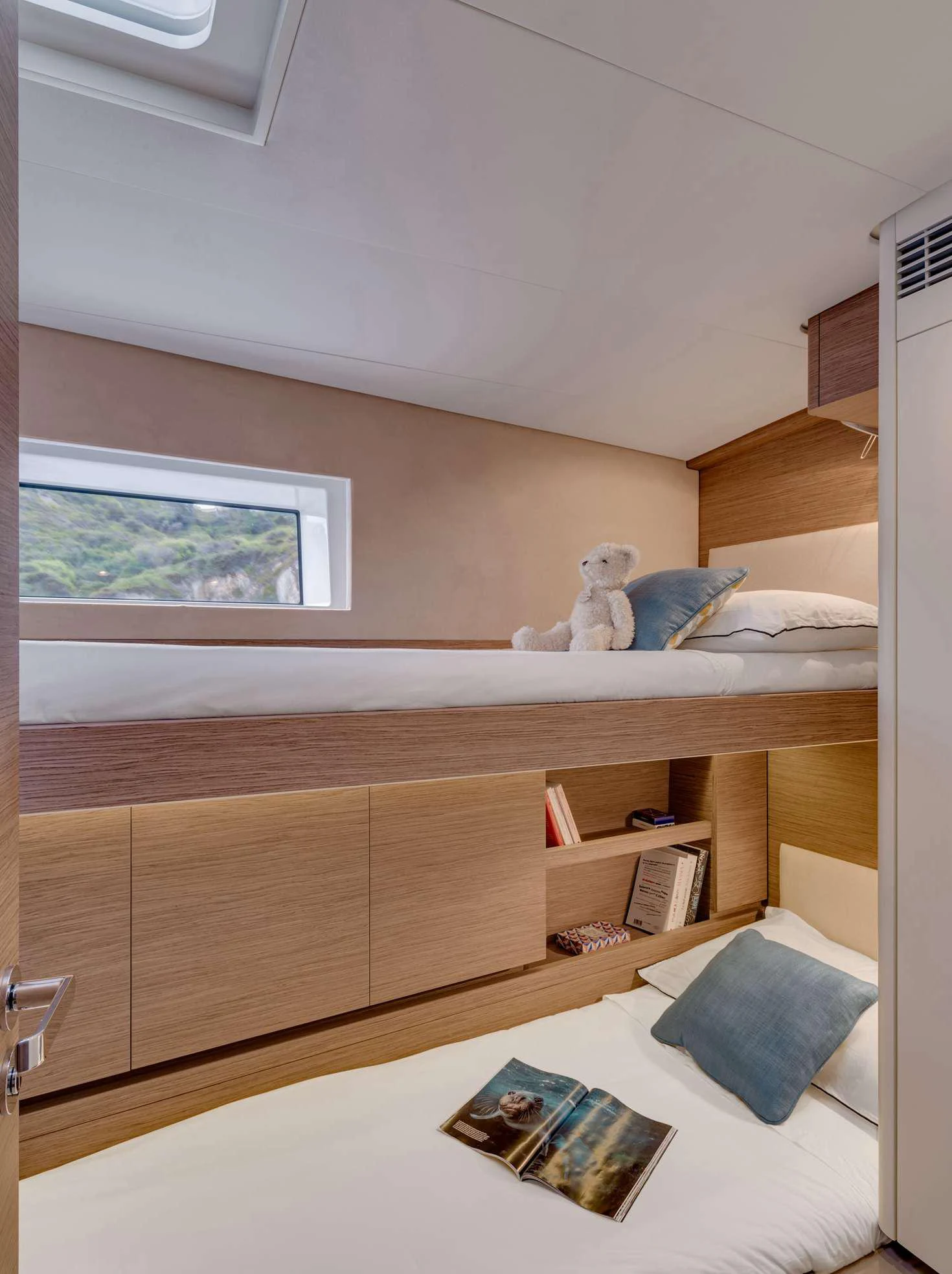 a white stuffed animal on a shelf aboard MAHINA 3 Yacht for Charter